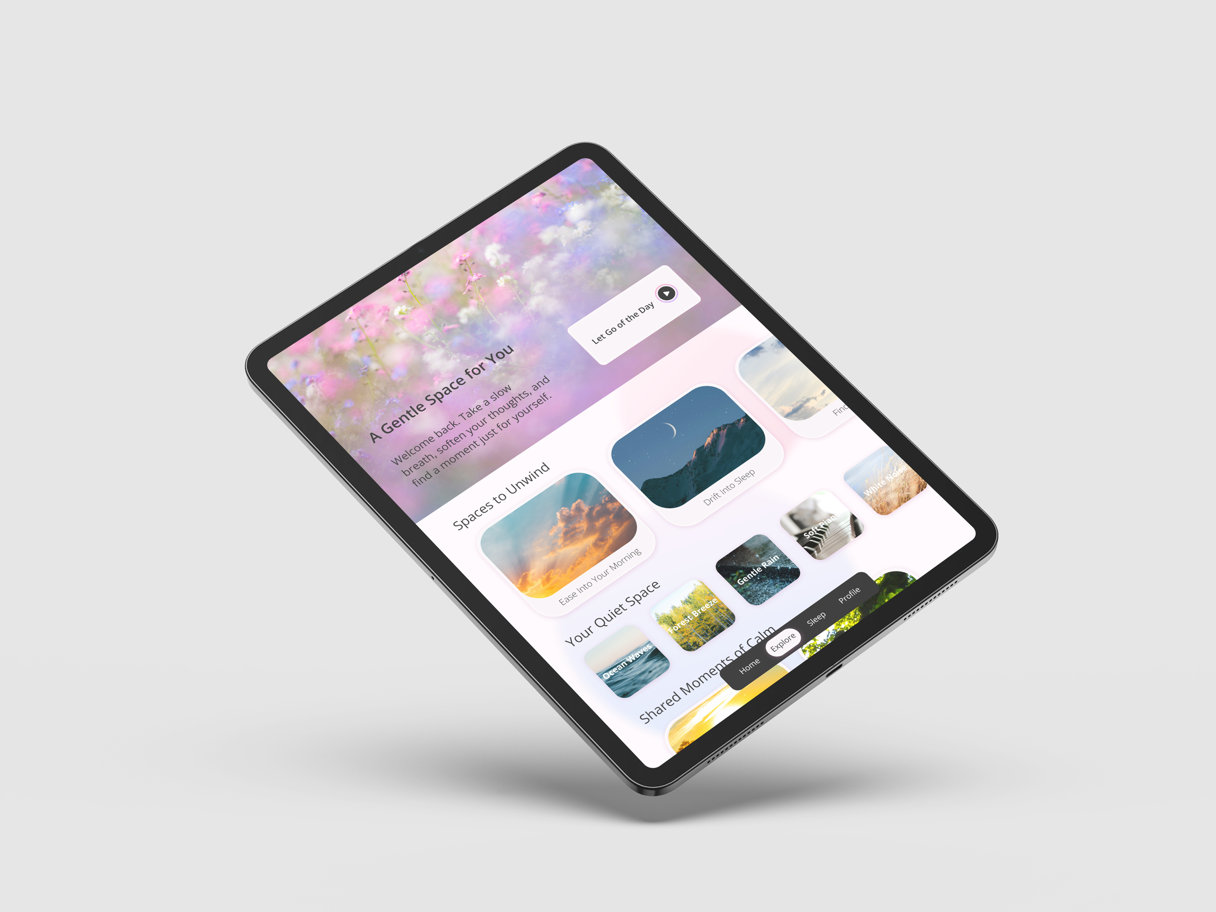 A close-up of a tablet screen displaying a meditation or relaxation app with soft pastel colors, photos of nature, and options for different calming sounds and images.
