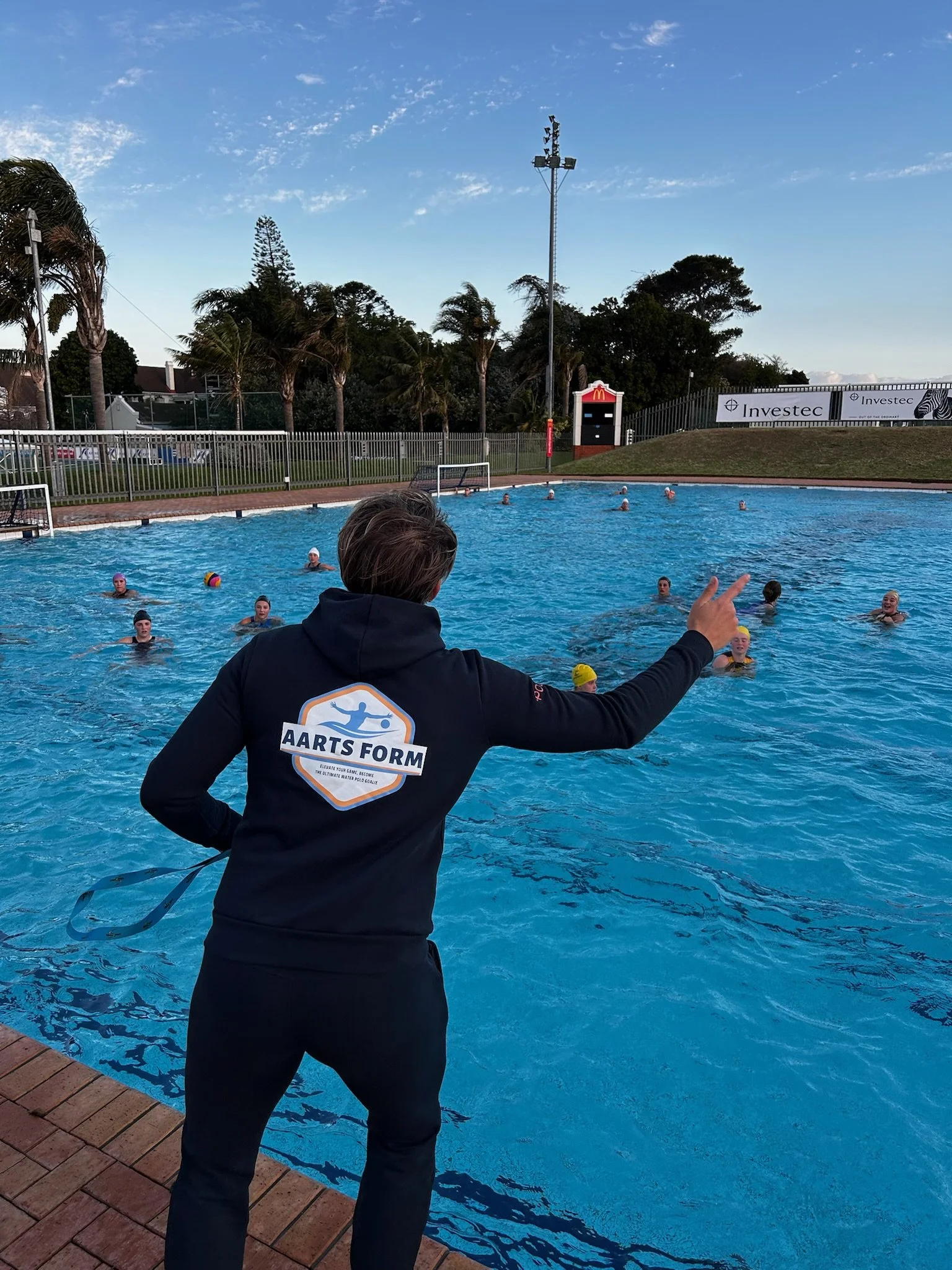 Laura Aarts coaching water polo goalkeepers during an outdoor training session.