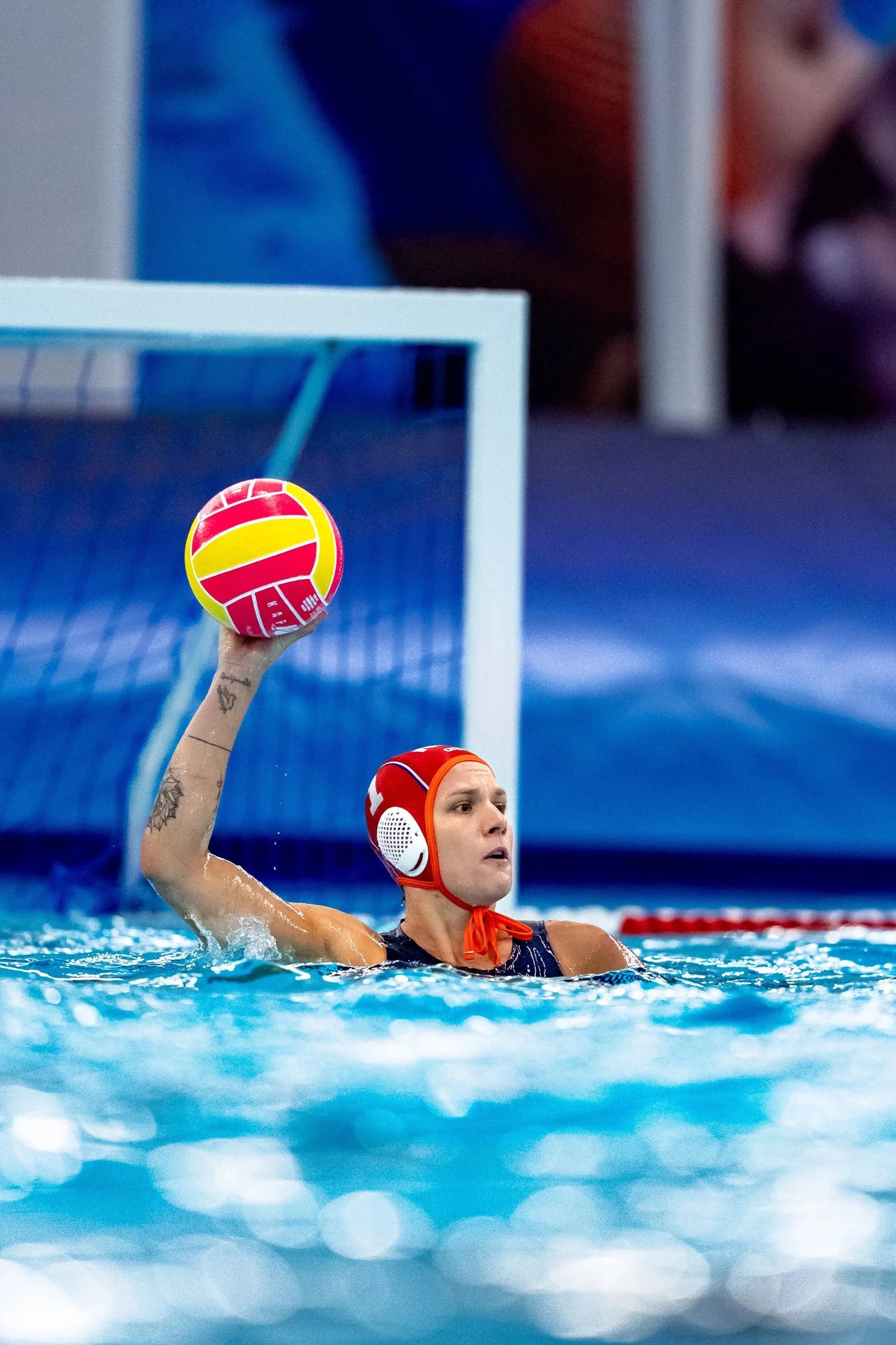 Water polo goalkeeper, Laura Aarts, with ball in the hand during a match.