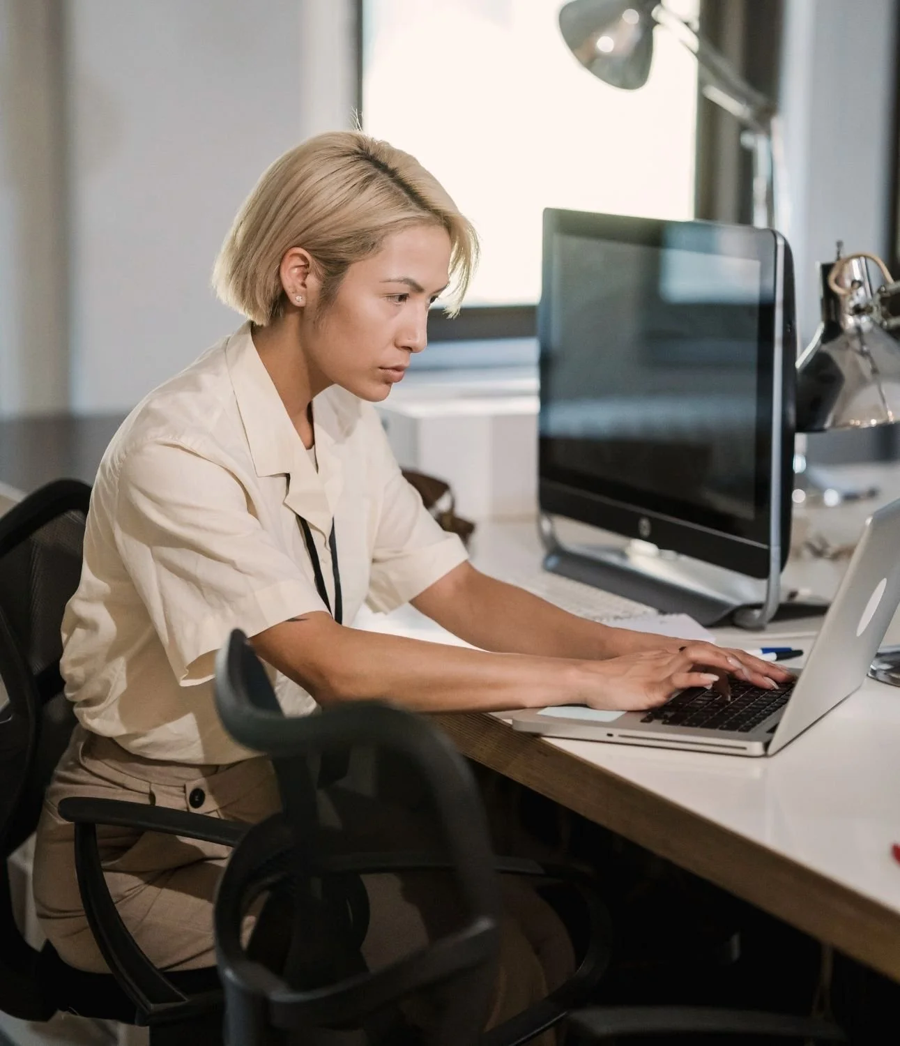 Professional working at a computer on resources supporting multiple chemical sensitivity research and education.
