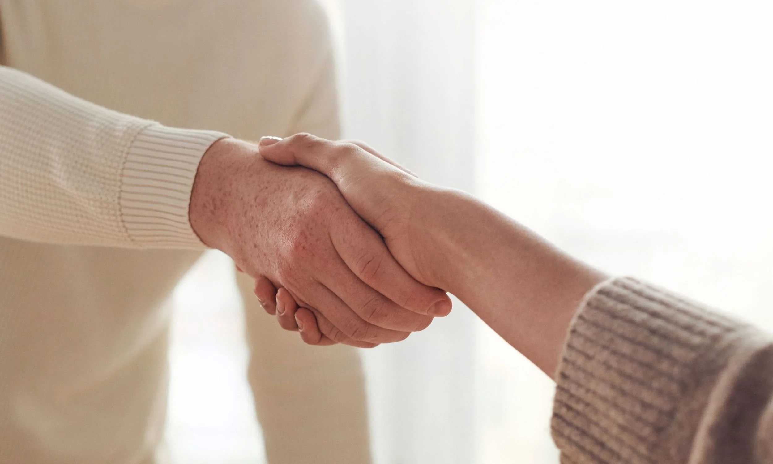 Handshake representing collaboration, advocacy, and support for multiple chemical sensitivity research.