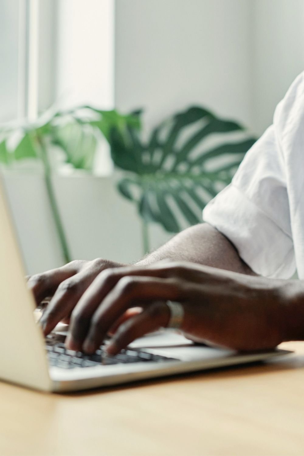 Person using a laptop to access research and educational information about healthy indoor air quality and multiple chemical sensitivity.