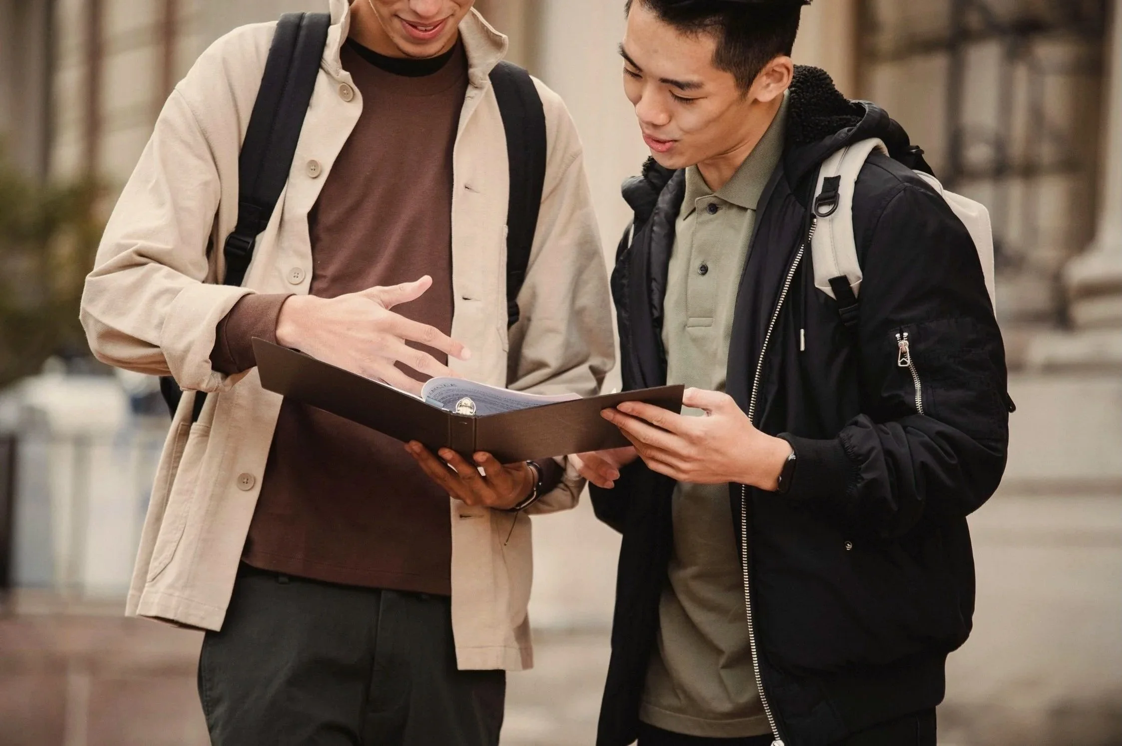 Two people reviewing educational materials related to multiple chemical sensitivity research and awareness.