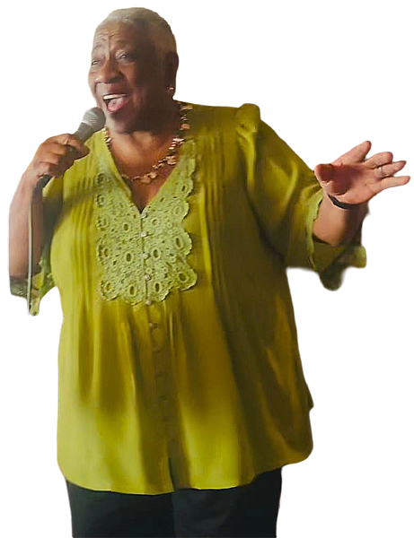 Joyce Randolph singing, holding a microphone, wearing a lime green top