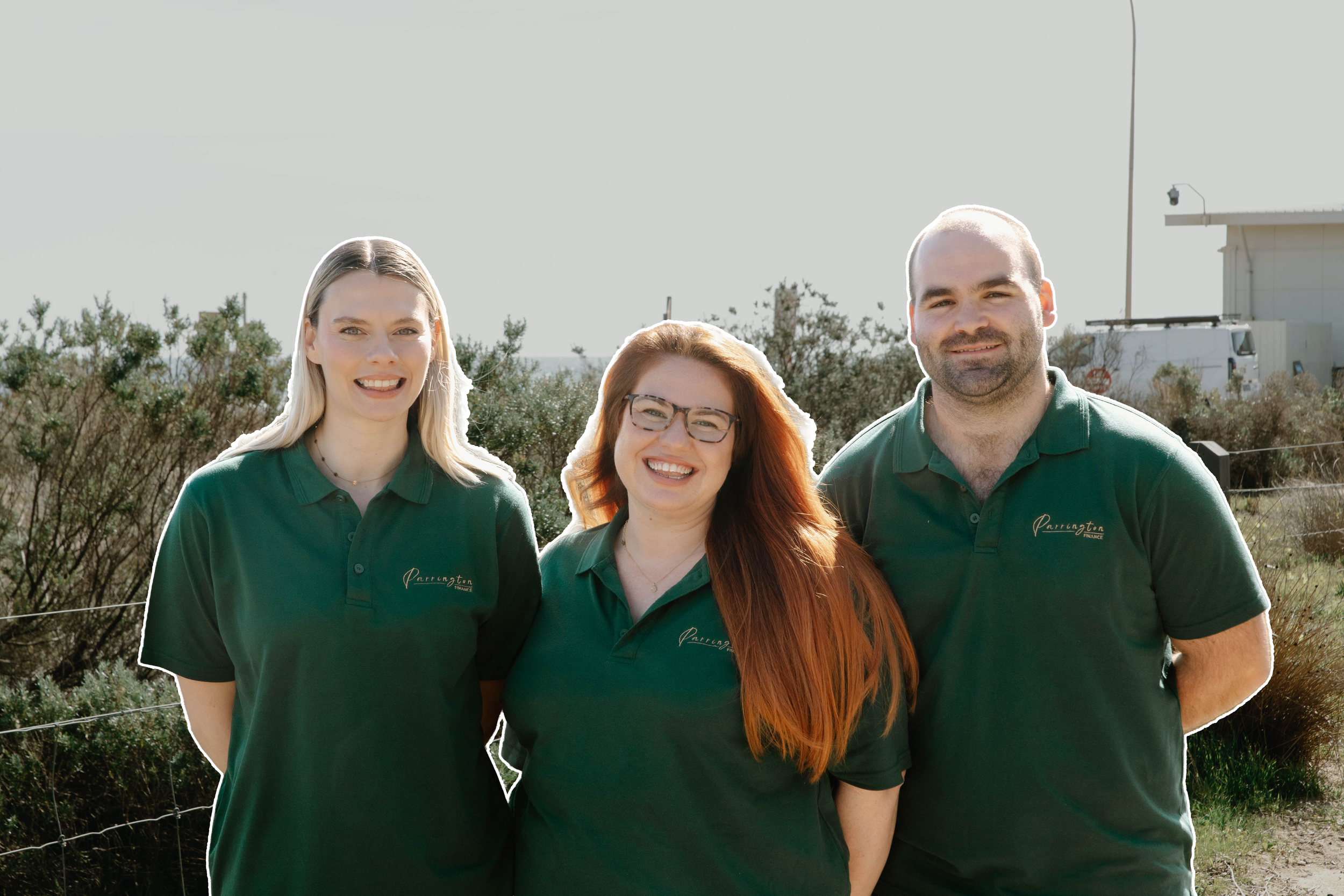 Three people standing outdoors on what appears to be a sunny day, wearing matching green polo shirts with a logo that reads 'Parrington Finance'.