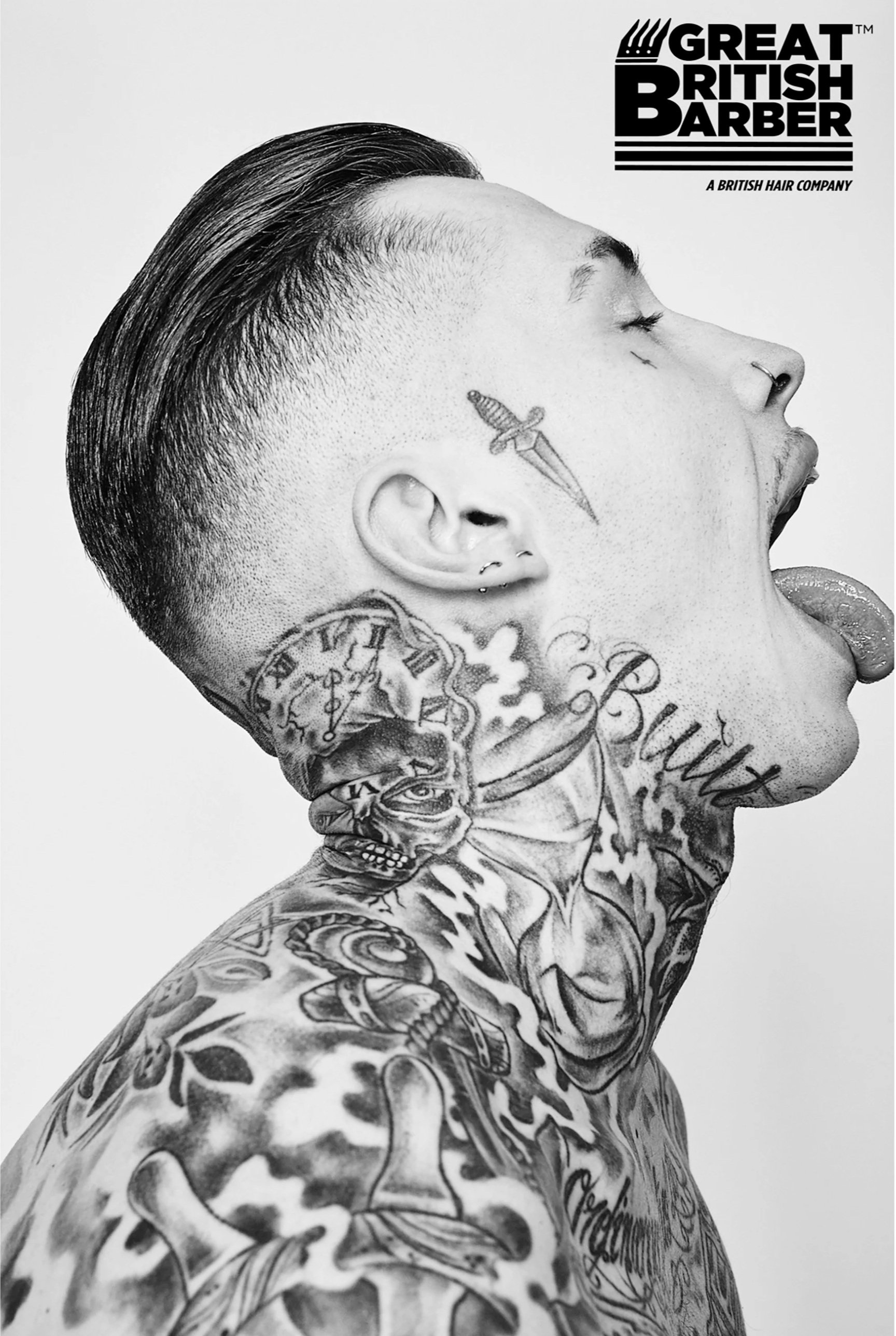 Black and white photograph of a person with tattoos on their neck, shoulder, and face sticking out their tongue, with their eyes closed and head tilted back.