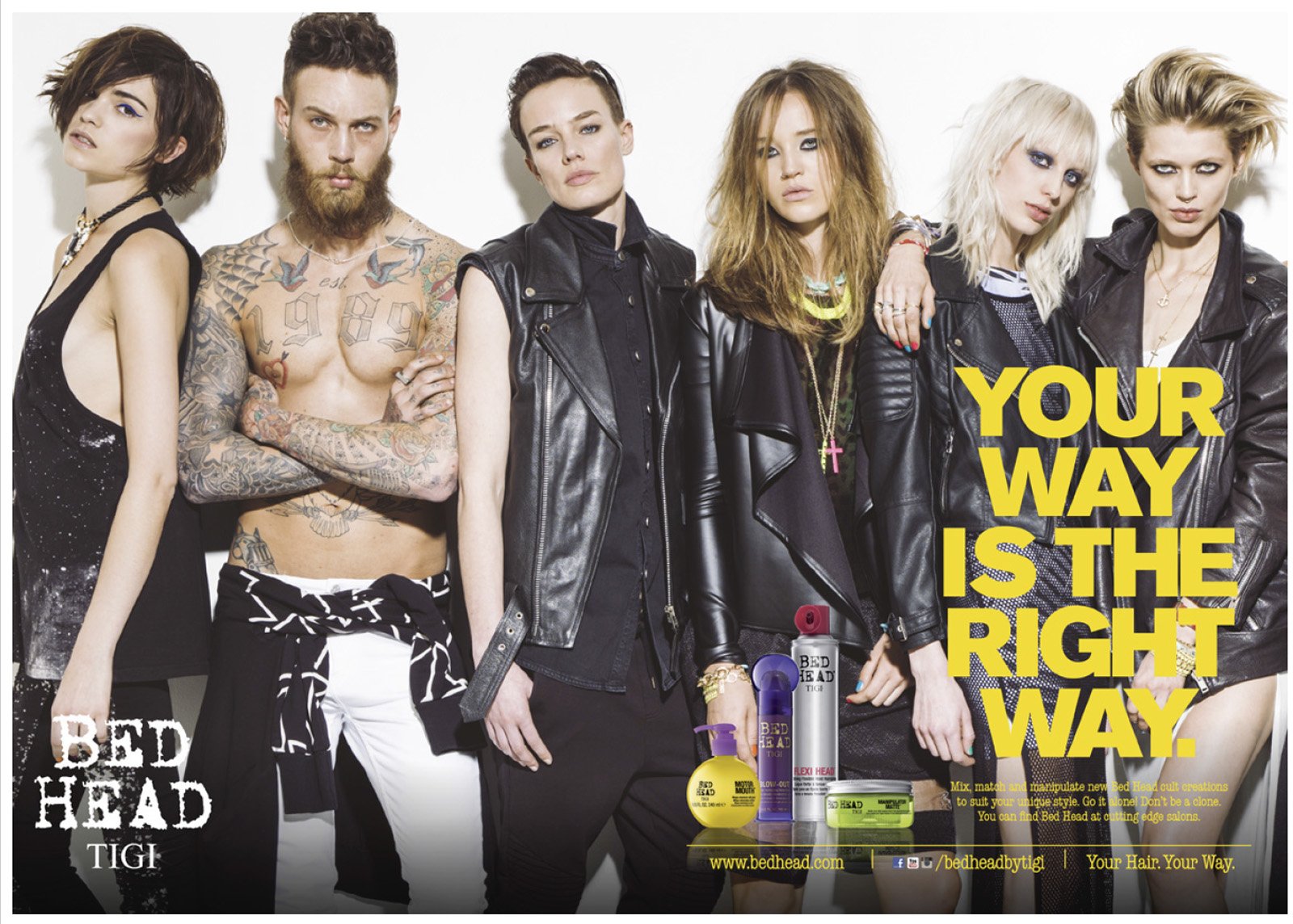 Group of six young models with edgy hairstyles and makeup, wearing leather jackets, posing together against a white background, with Bed Head hair care products and promotional text overlayed.