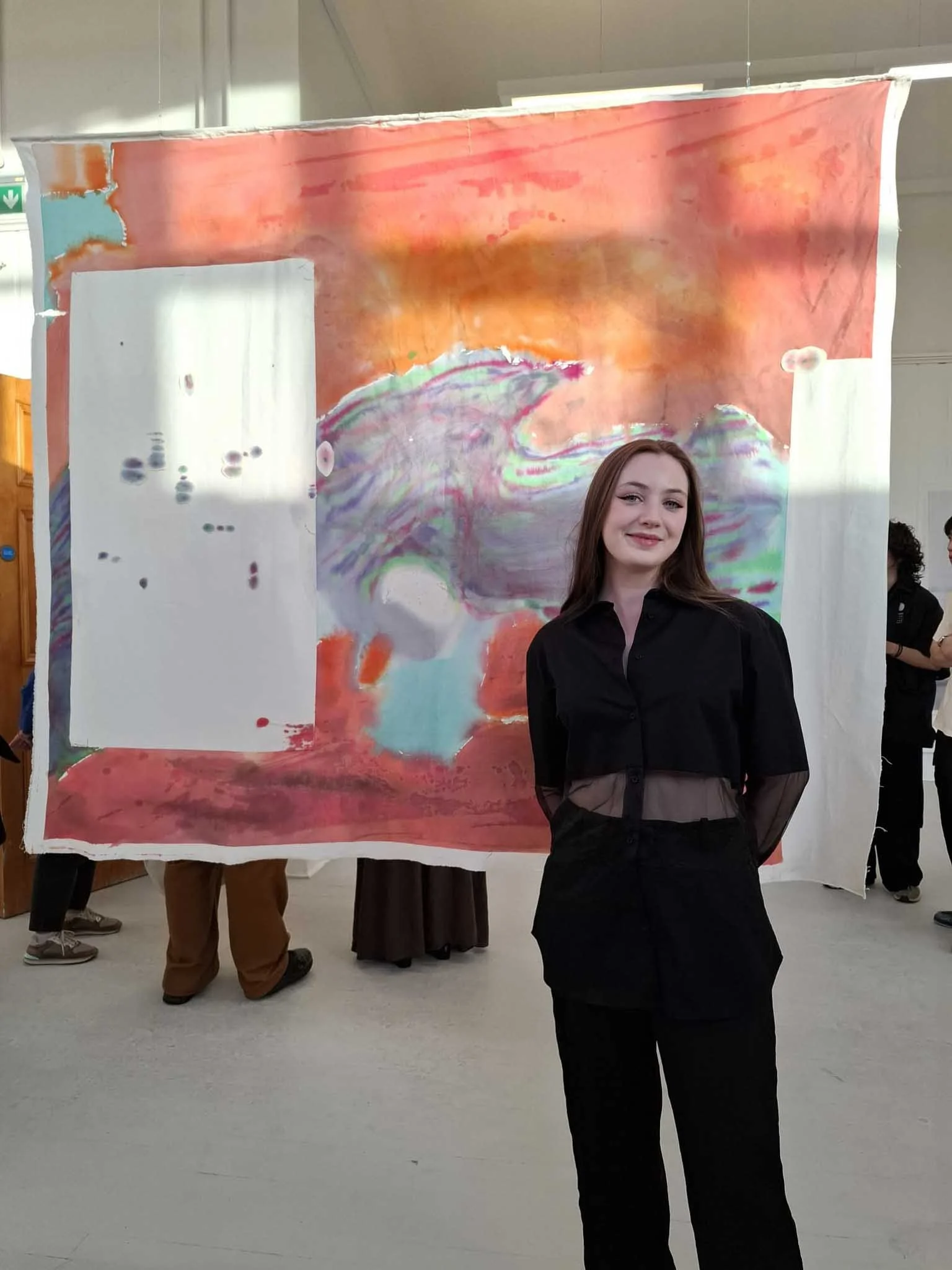 Contemporary artist Annabelle Pelaez with her painting at the Edinburgh College of Art Graduate Show 2025.