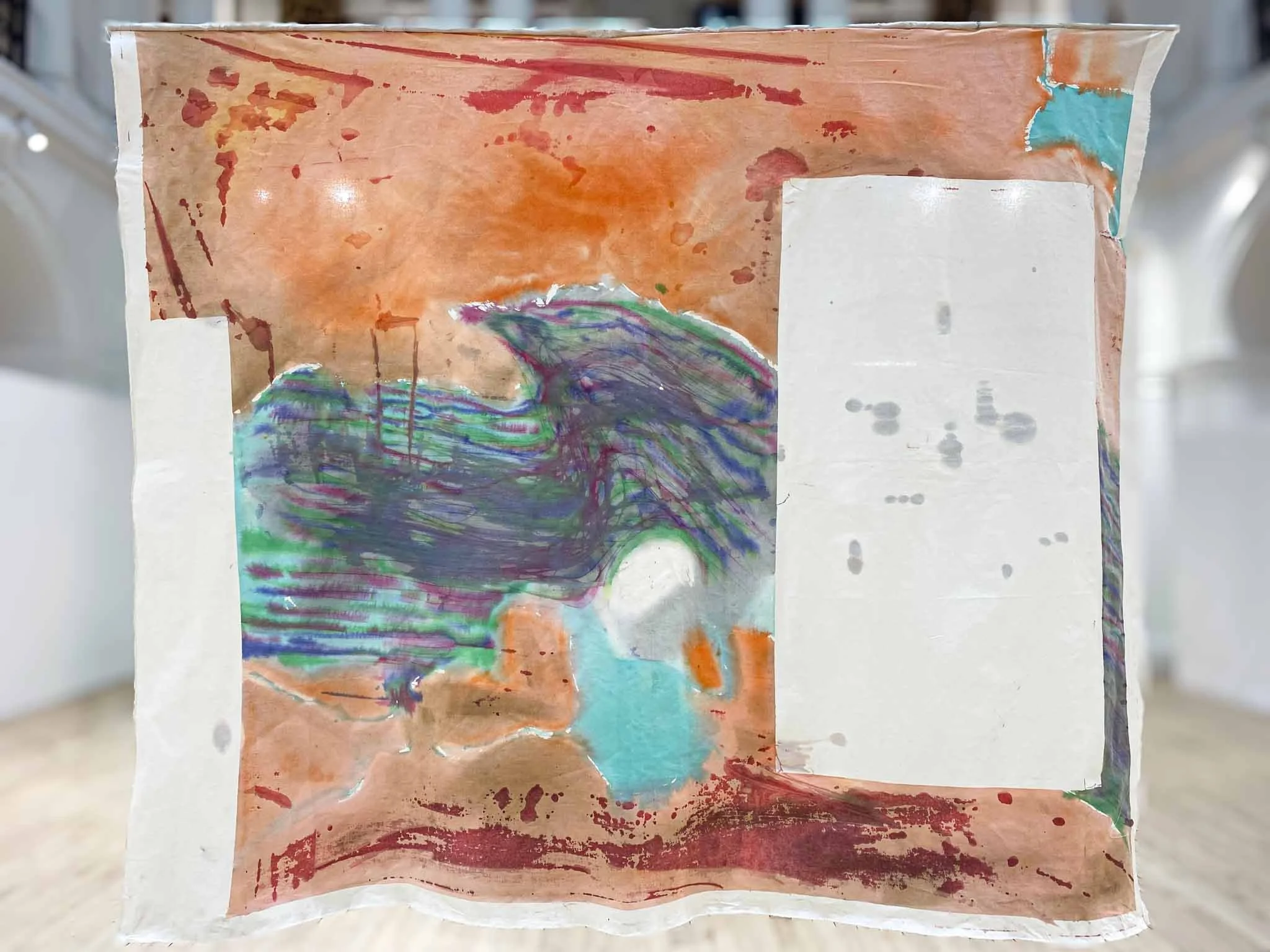 Abstract artwork featuring a mix of orange, red, green, purple, blue, and white colors with a textured and layered appearance.