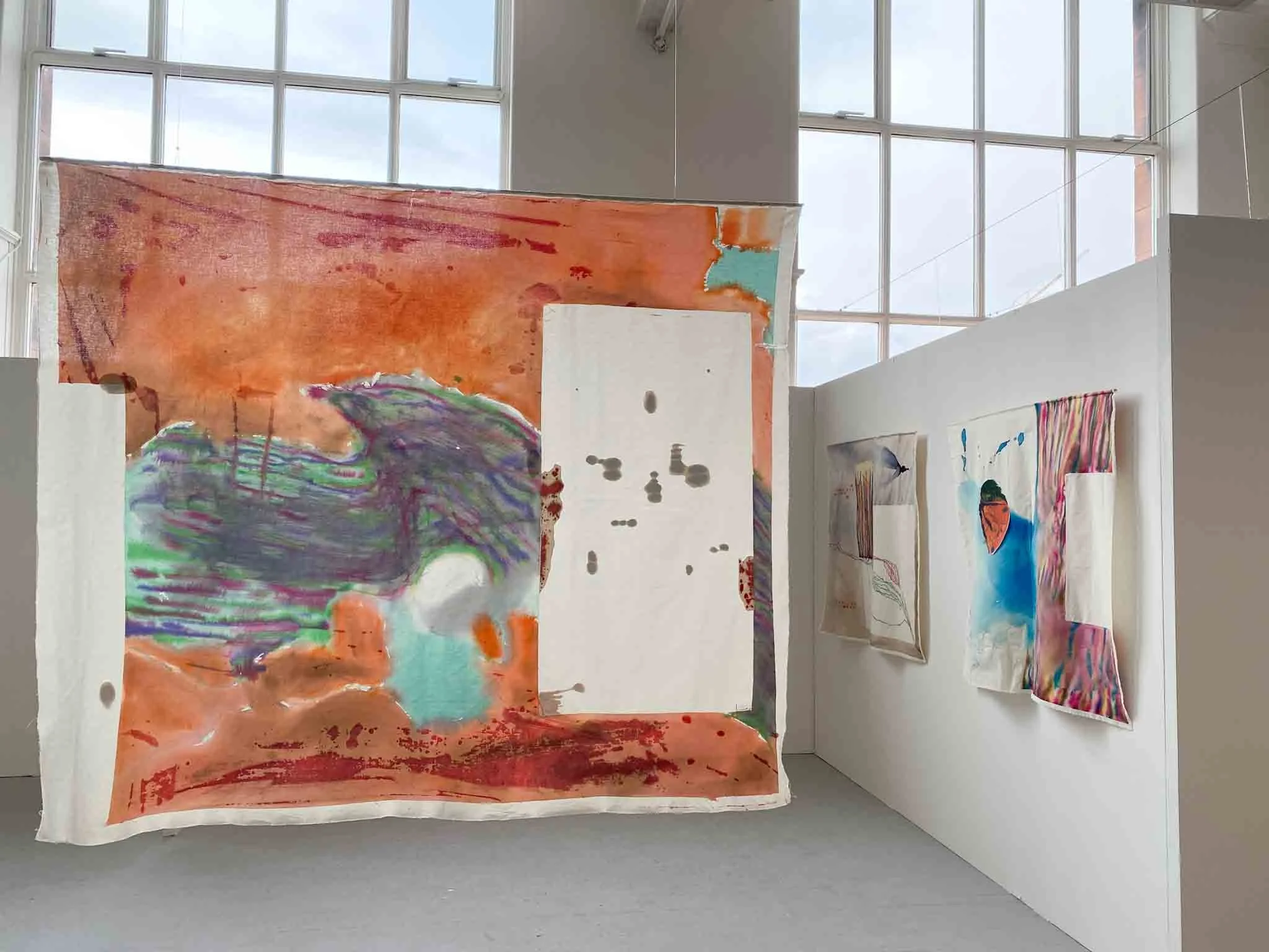 An art installation in a gallery with large windows. Installation view of contemporary artist Annabelle Pelaez’ graduate show.