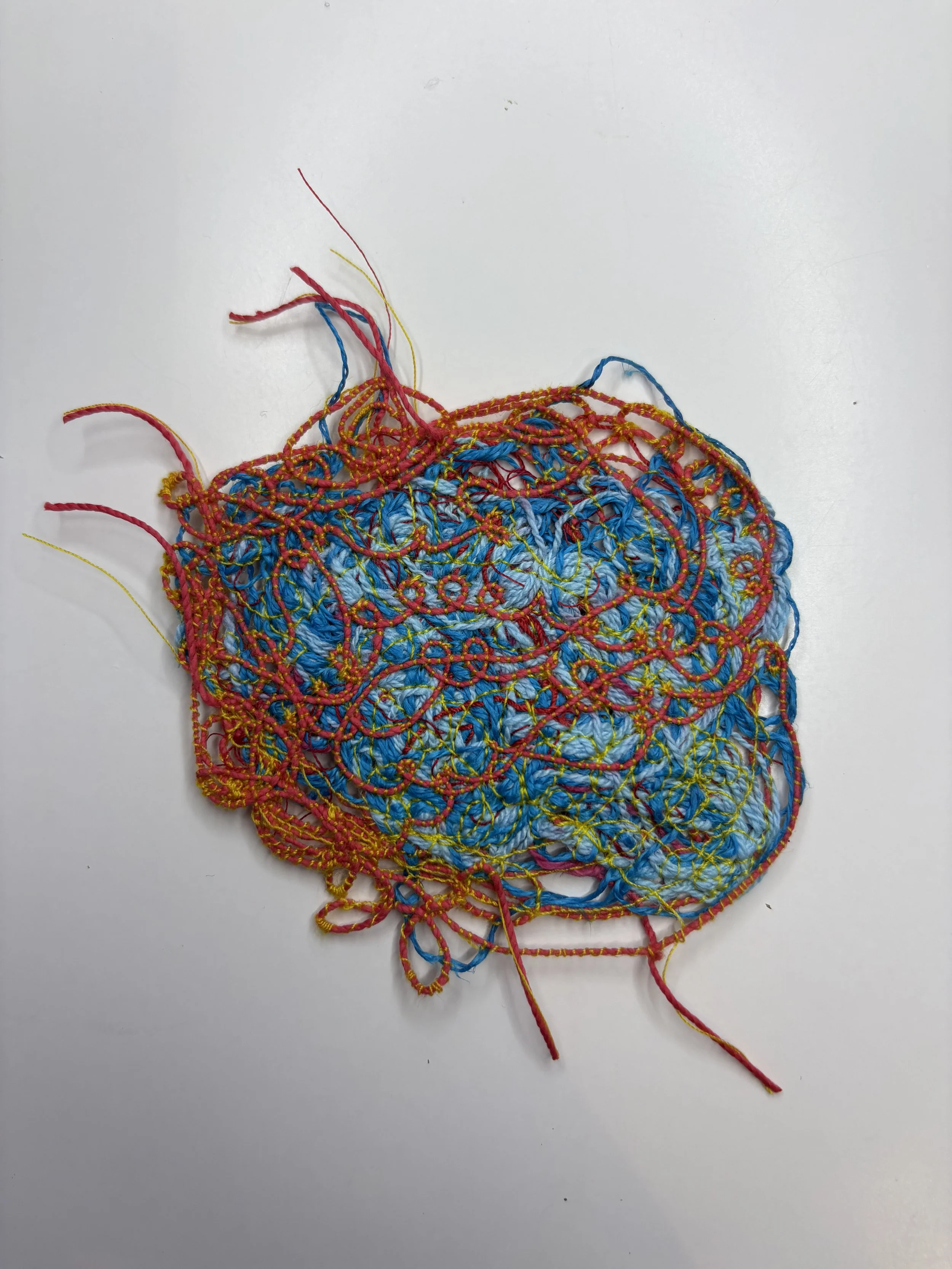 Colorful tangled yarn or thread on a white background.