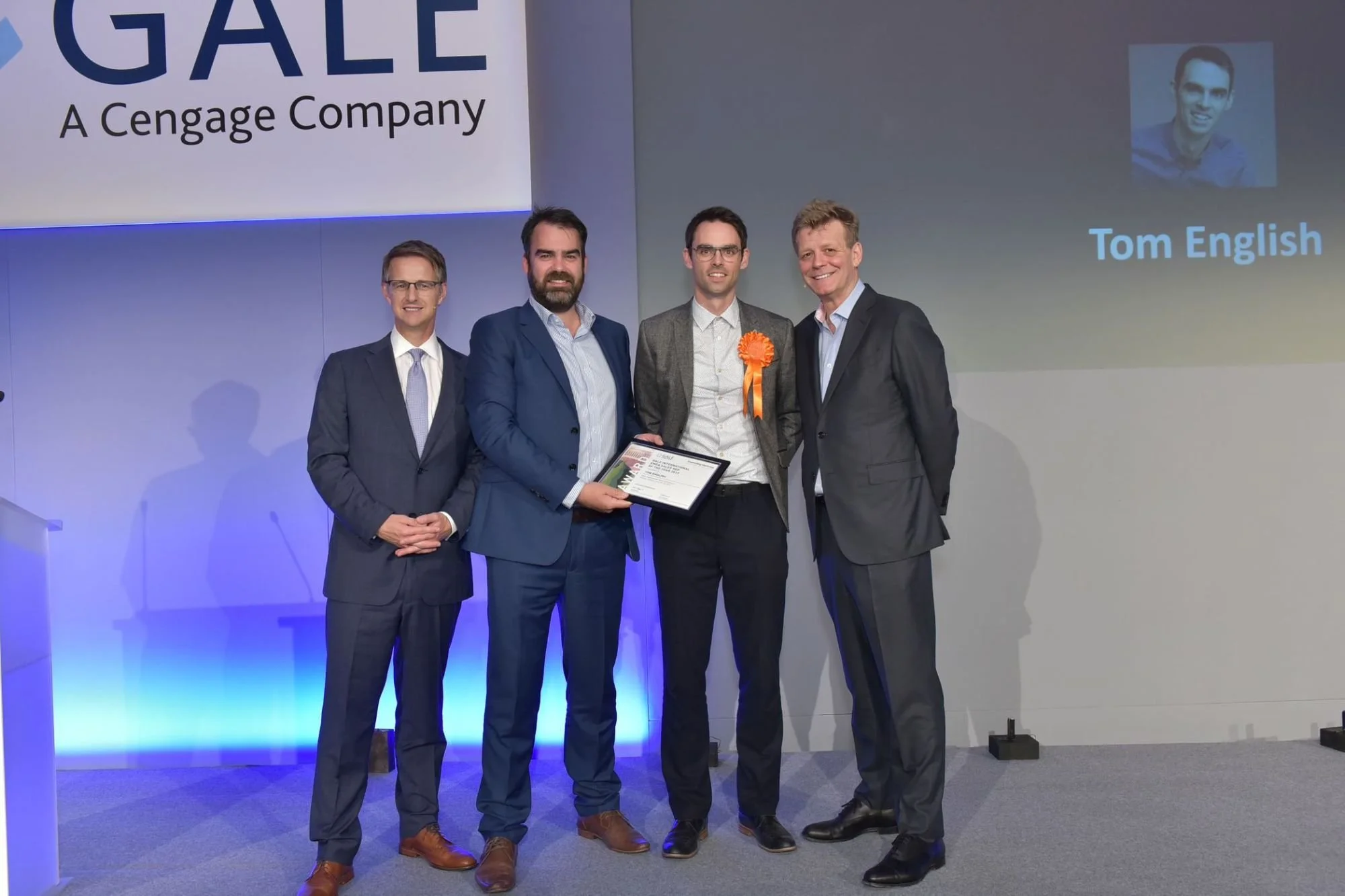 Tom English receiving a Gale sales award on stage
