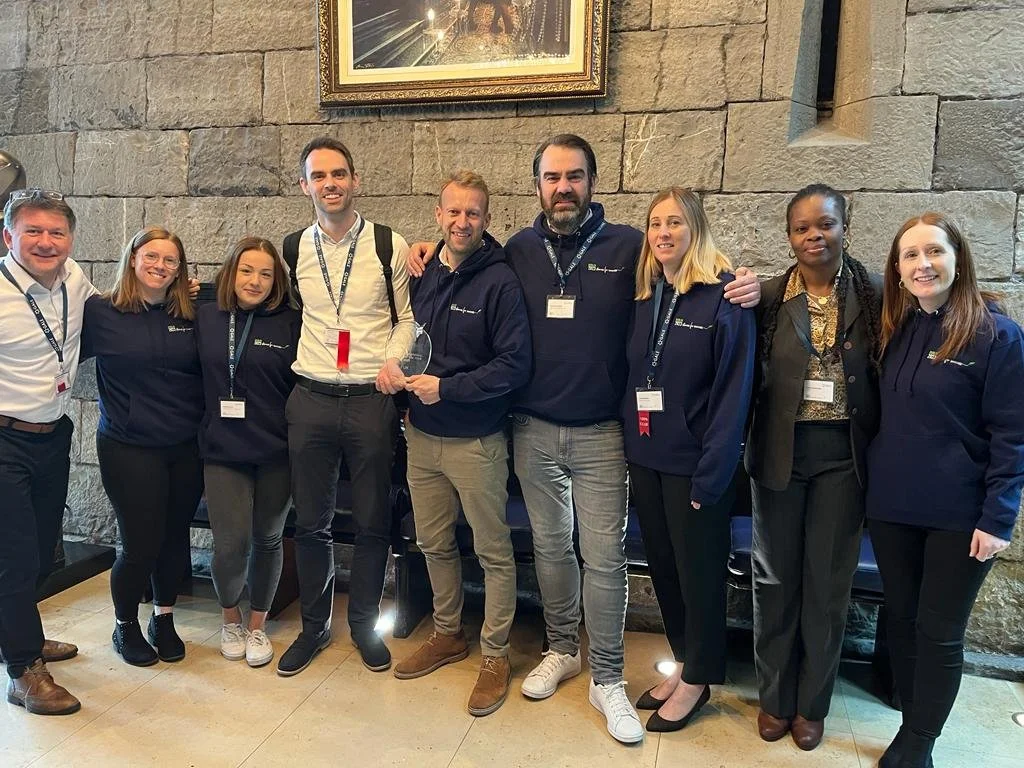 Tom with a sales team celebrating an award