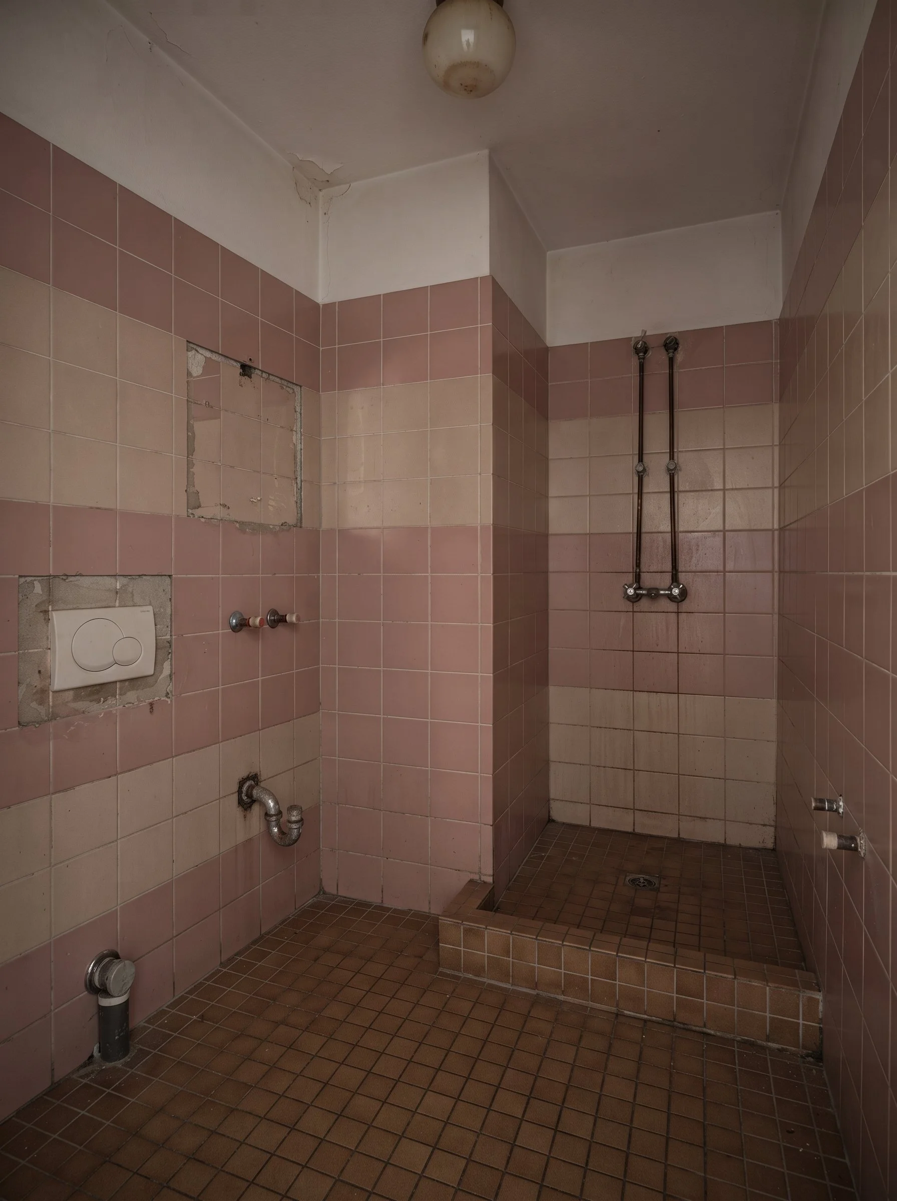 Empty_1980s_bathroom_bare_plumbing_202607271617.jpeg