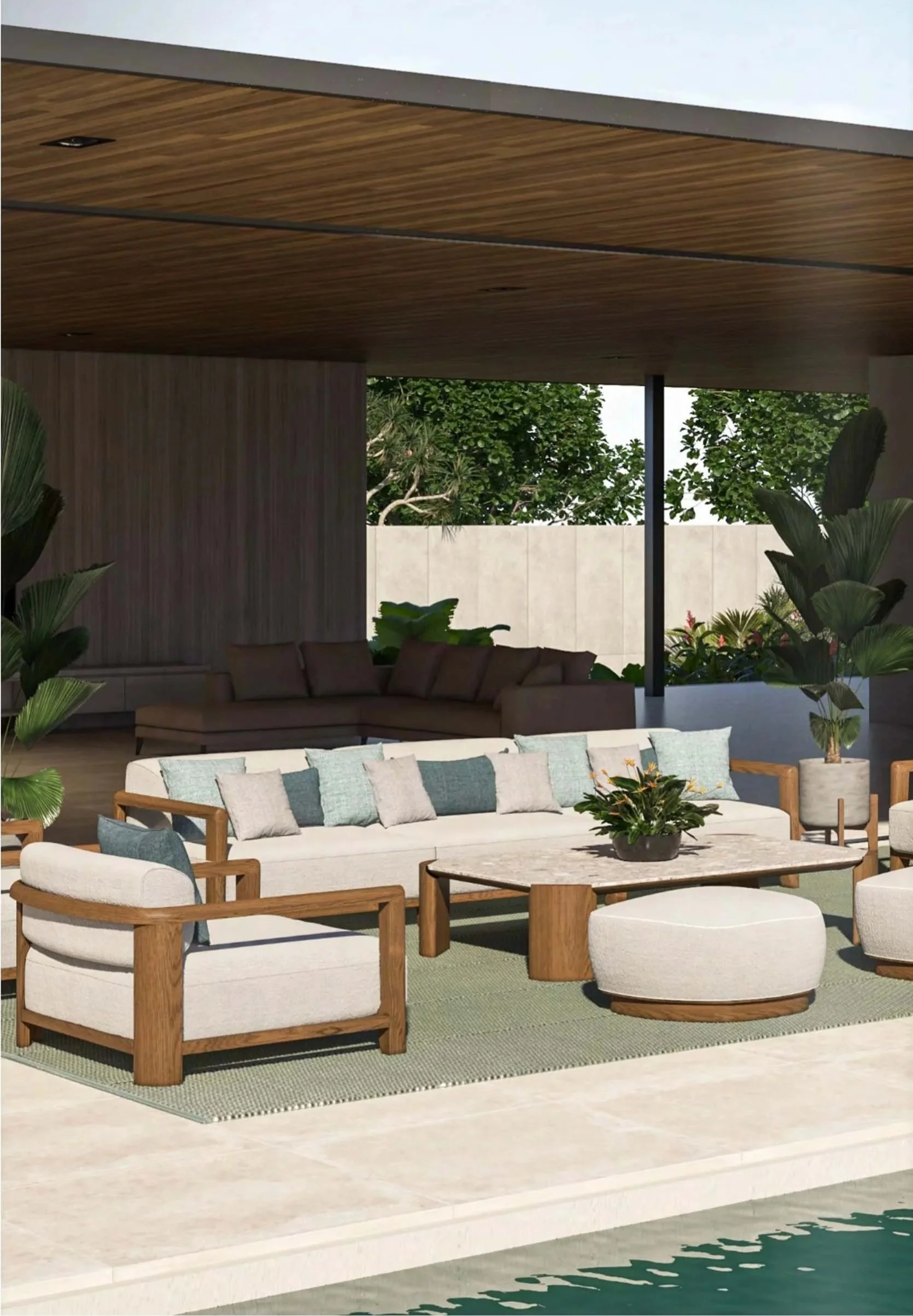 Outdoor patio area with modern furniture including a white cushioned sofa with blue and gray pillows, wooden armchairs, and a round coffee table with a plant. There are large green plants and trees in the background, and the scene is shaded by a wood