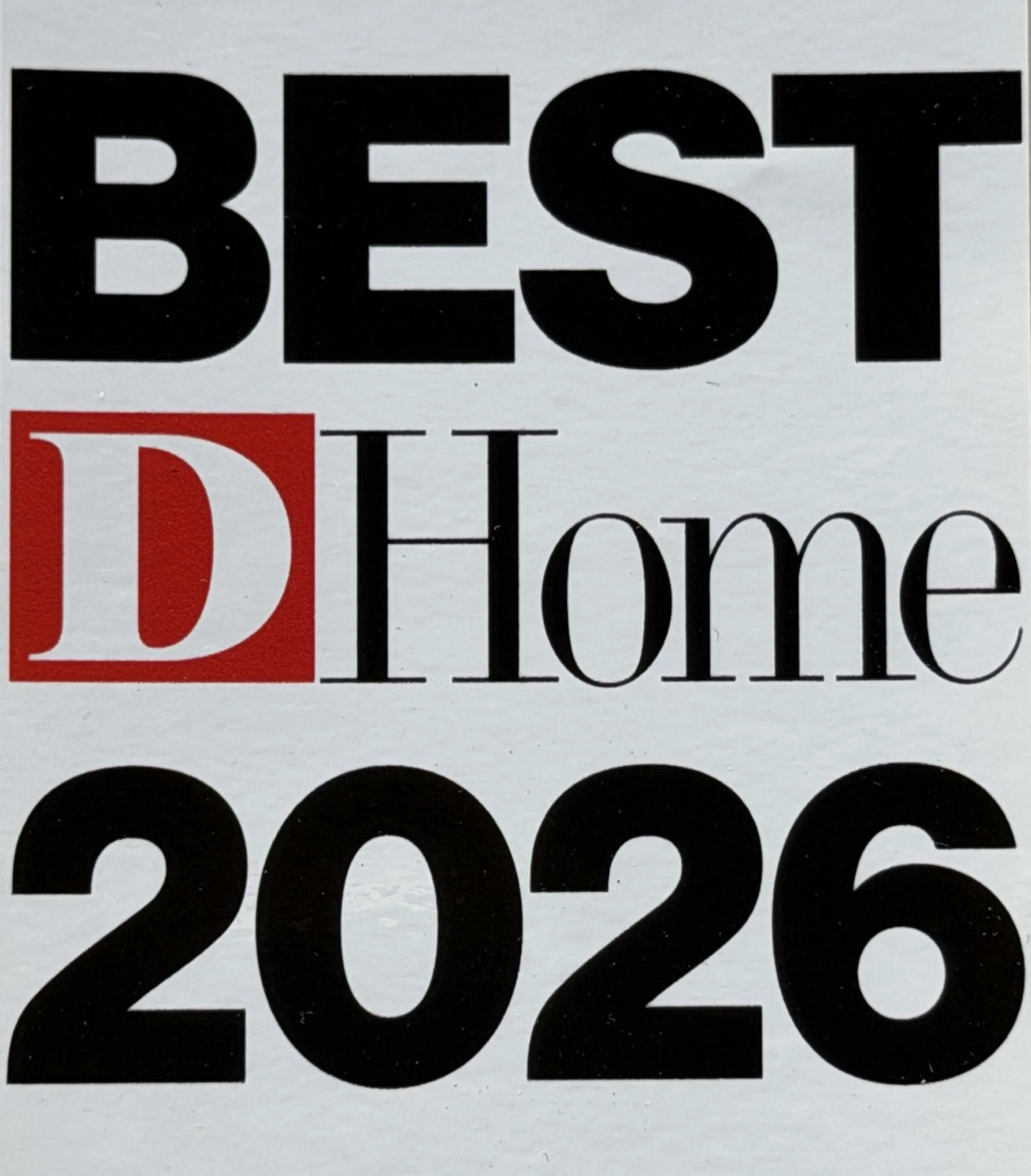 Close-up of part of a sign displaying the word "BEST" in large black letters, with the red part of the letters "D" and the partial word "Home" below.
