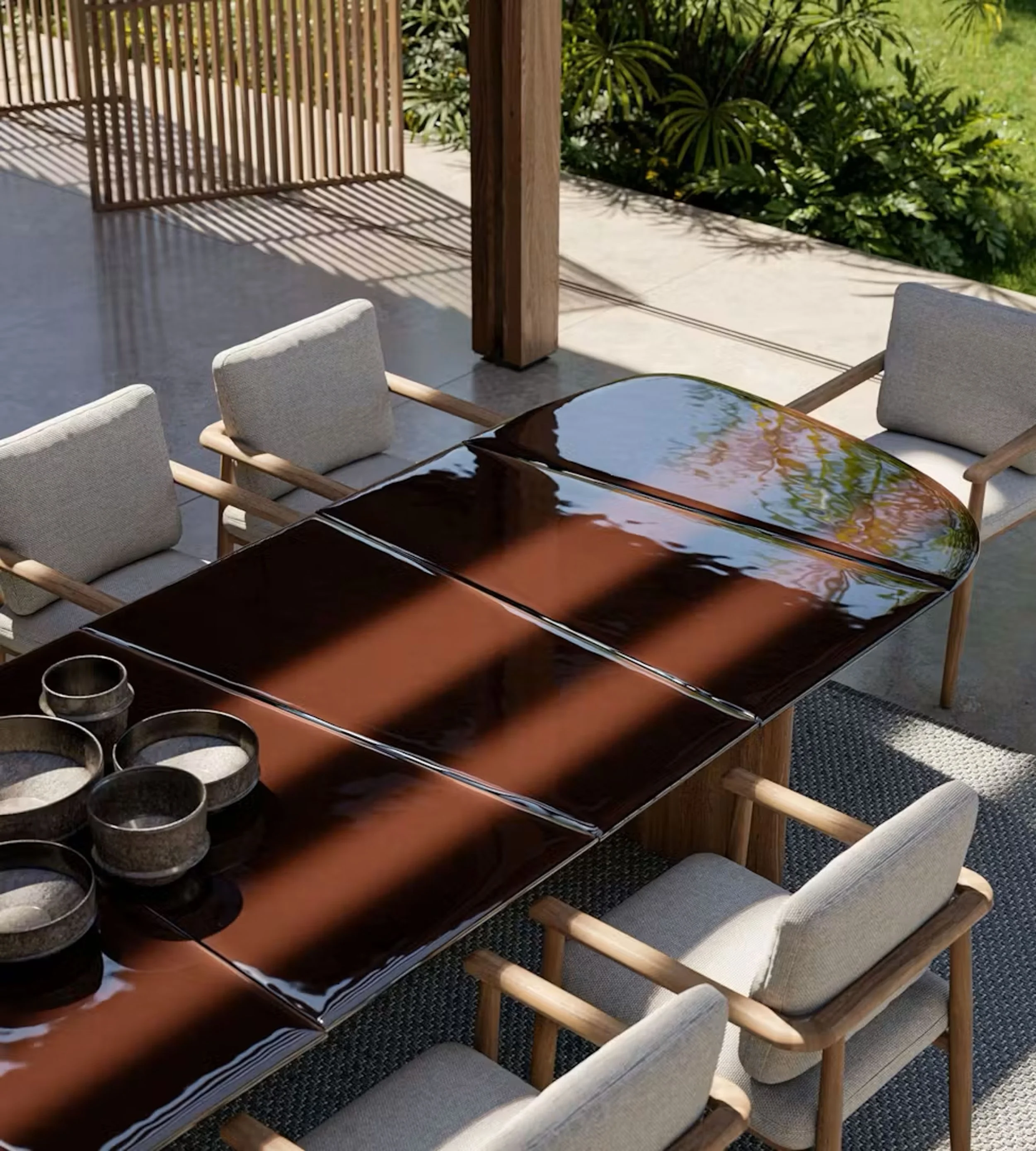 Outdoor patio with a wooden dining table and six cushioned chairs, surrounded by greenery and fence casting shadows.