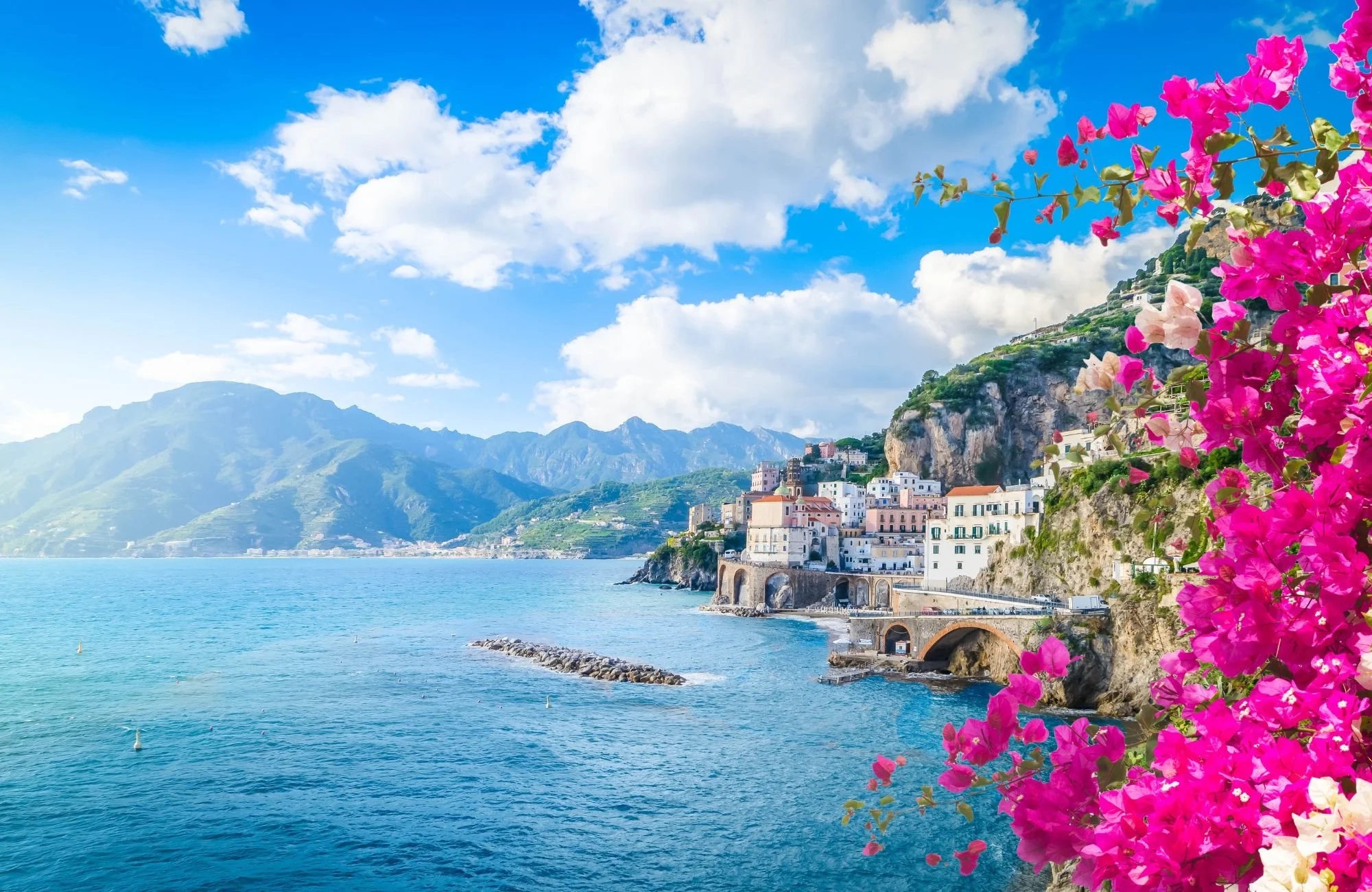 Coastal village overlooking the Mediterranean Sea with flowers and blue water