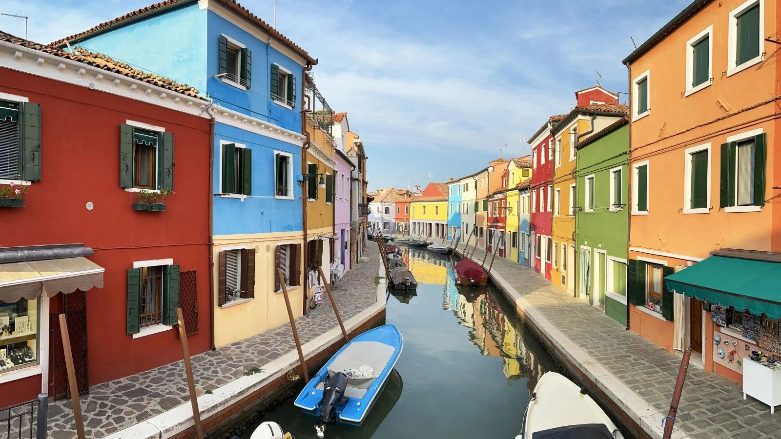 Colorful canal lined with historic buildings in Venice, Italy.