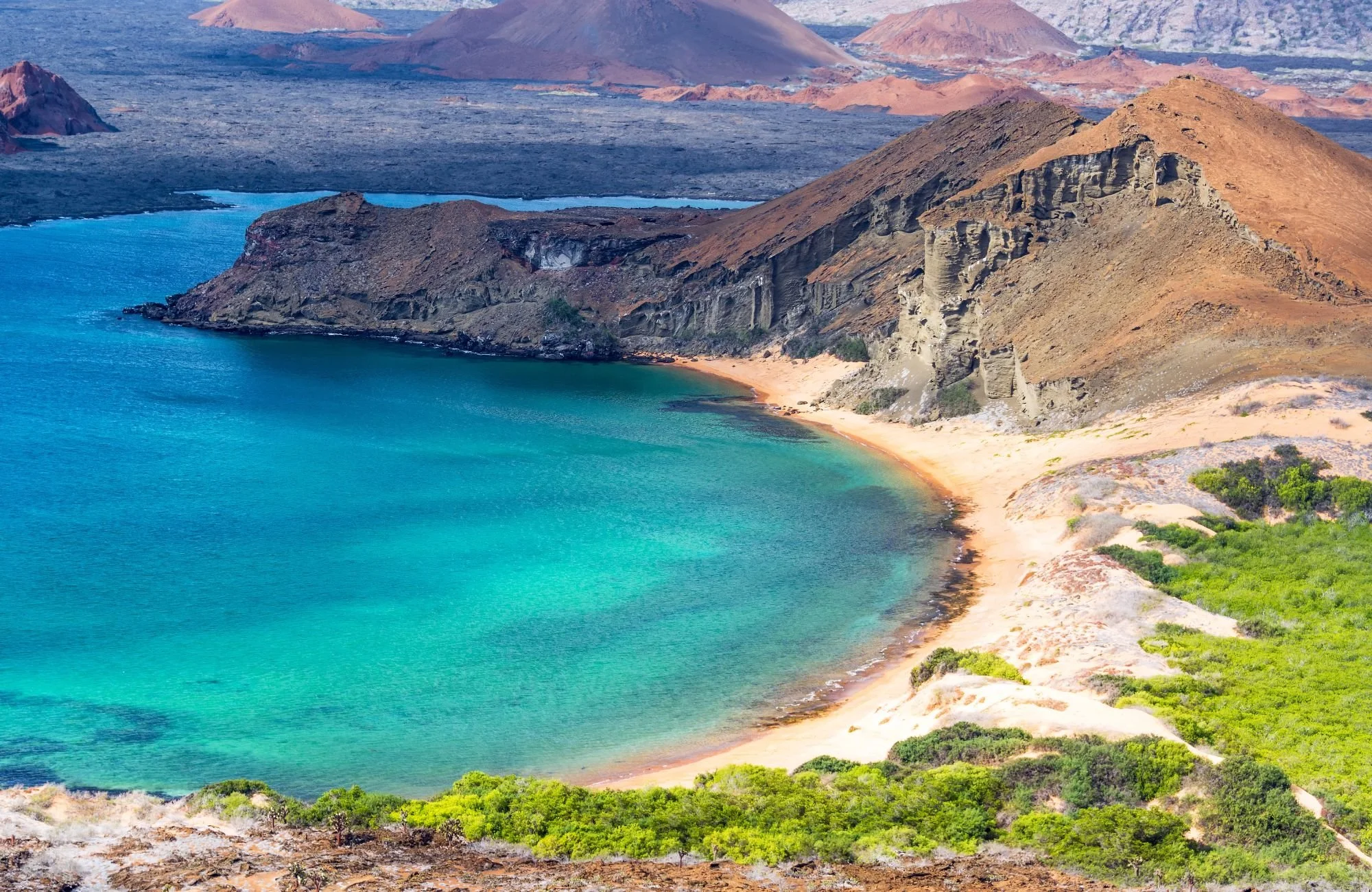The stunning Galapagos Islands showcasing the remote land, small shoreline and blue waters.