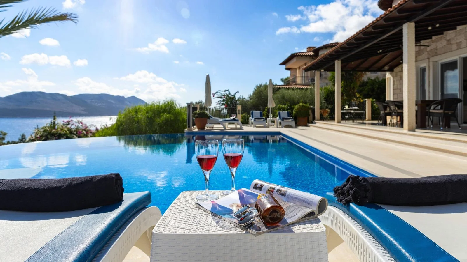 Luxury beach resort with a private pool overlooking the ocean, representing vacation budgeting and travel planning.