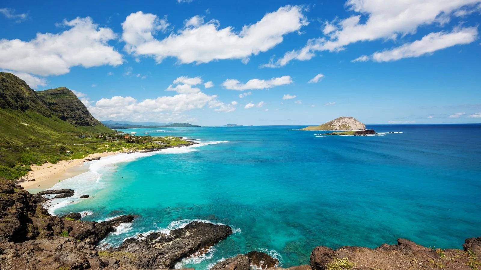 Scenic Hawaiian coastline with turquoise water and rocky cliffs.