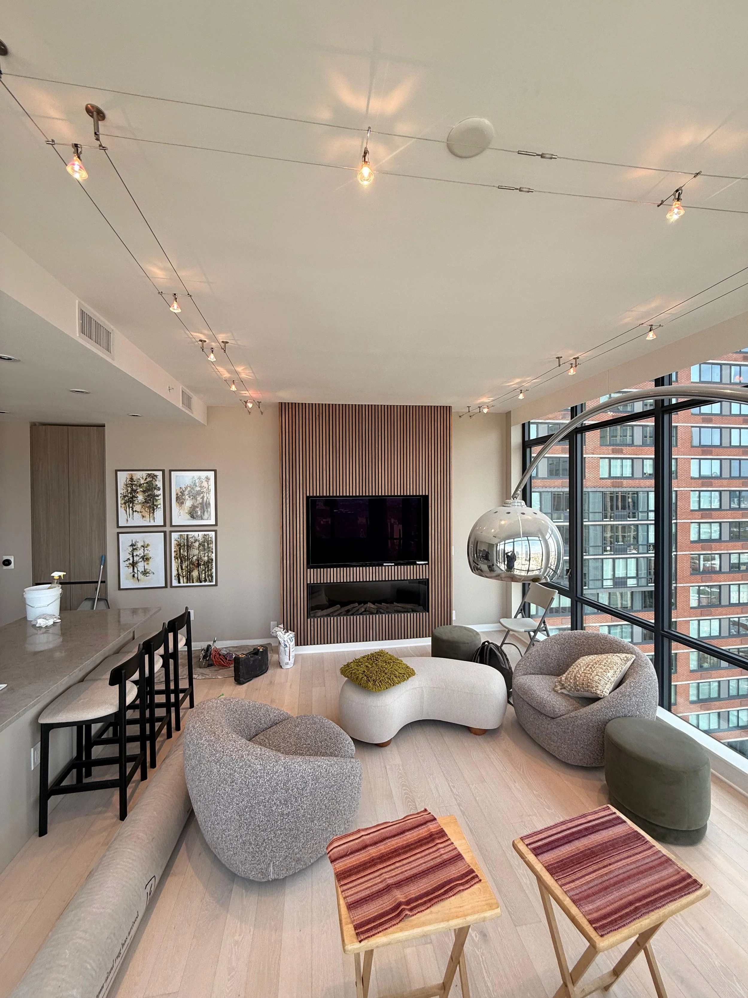 Specialty cable lighting installation and custom fireplace/TV area with wood paneling