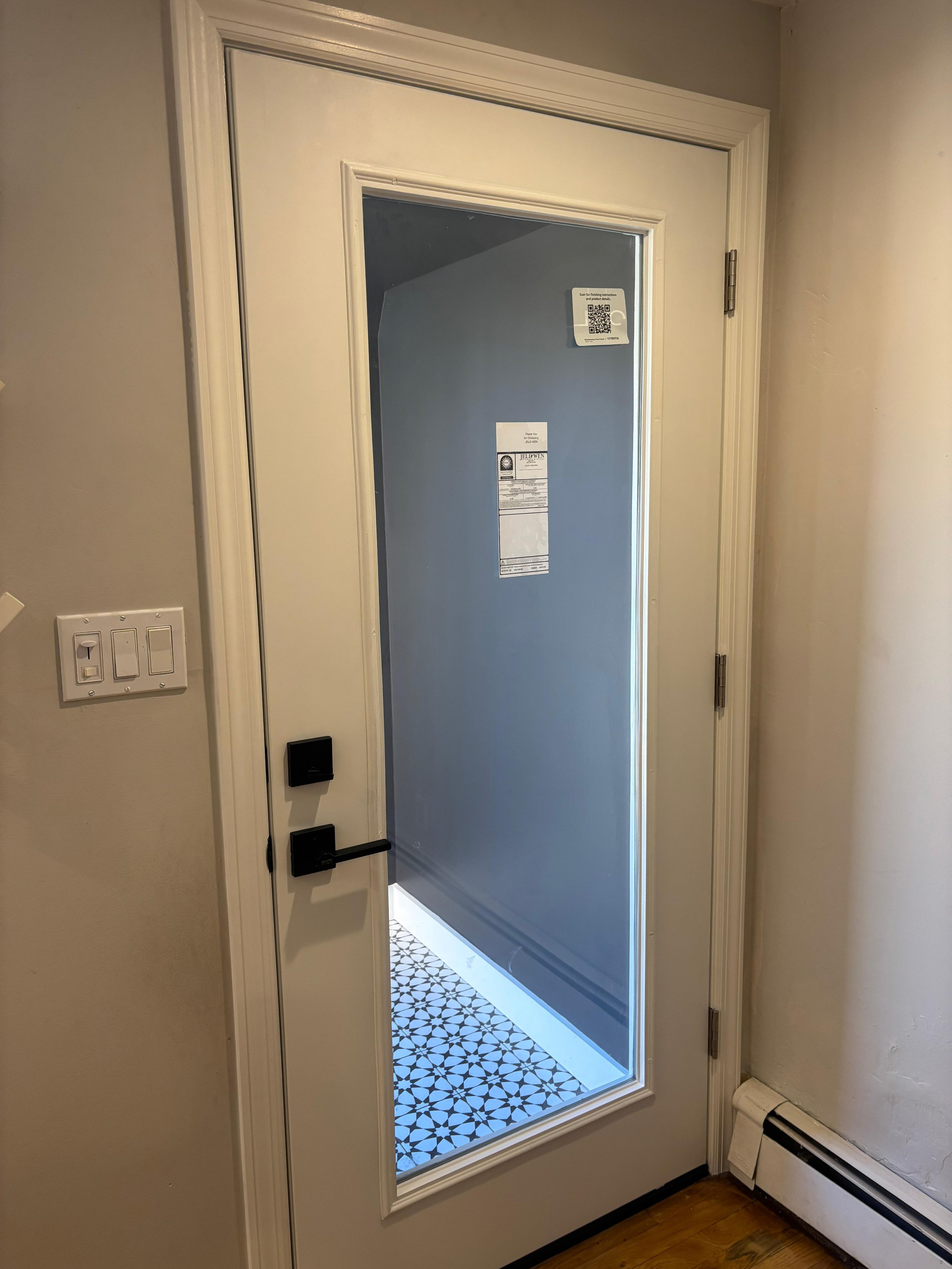 New tiled floor garden level entryway and new door to entryway