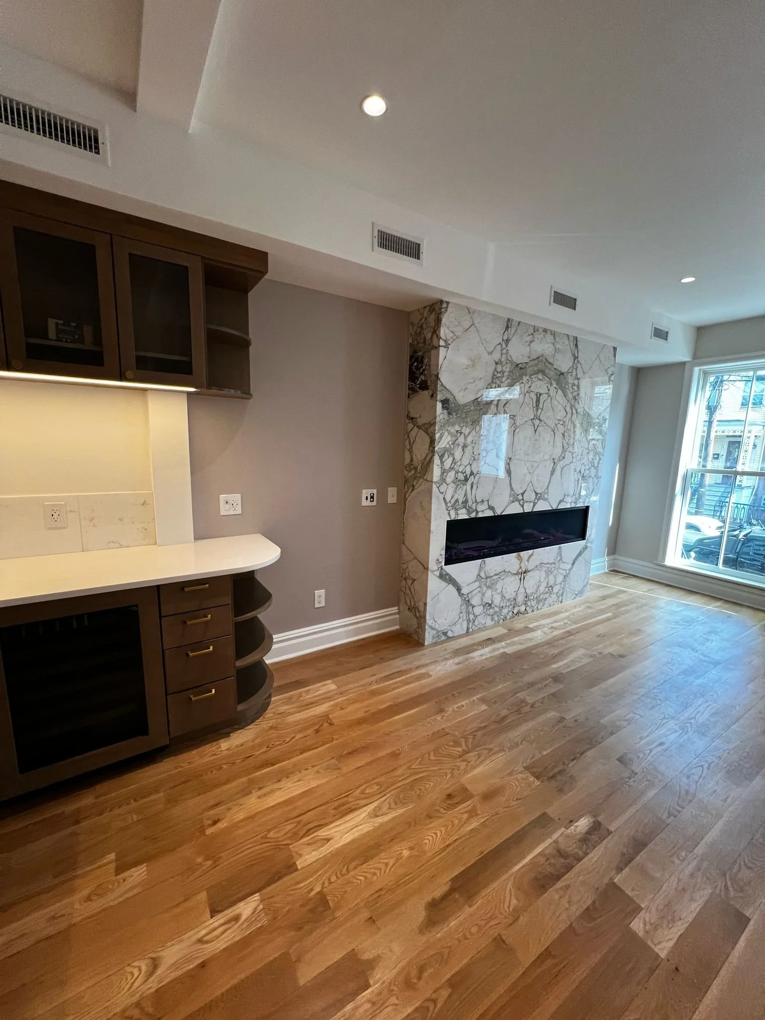 New wet bar and gas fireplace with marble front