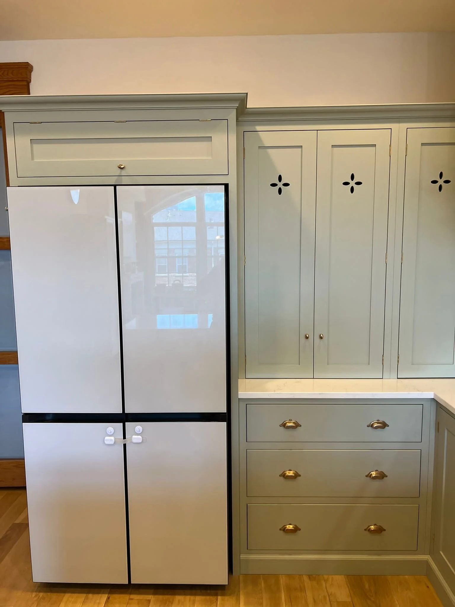 BeSpoke Samsung refrigerator and custom cabinetry with custom flower cut out in doors