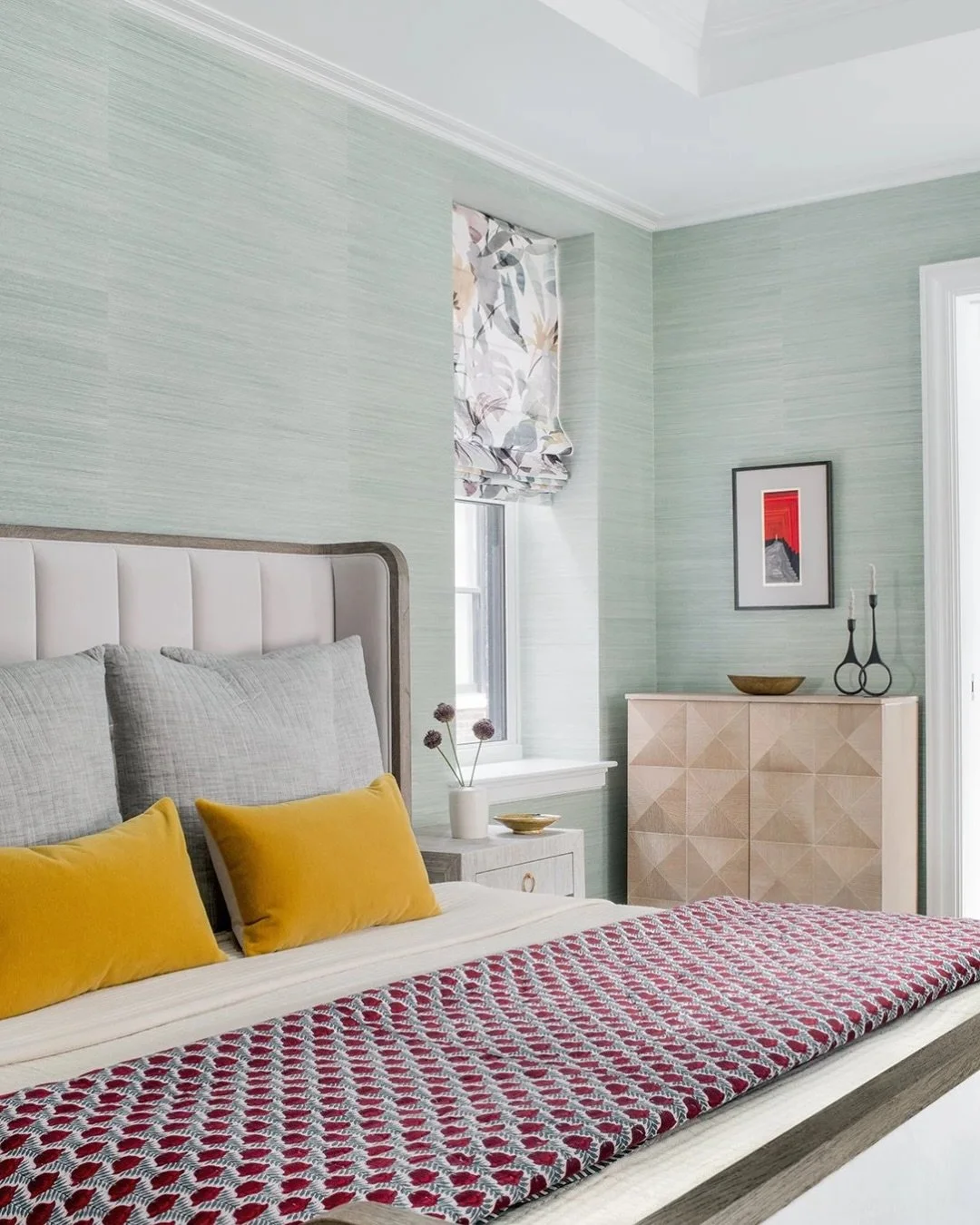 A minty green bedroom moment 💚

We fell in love with this wallpaper and used it as the inspiration for the rest of the space. Soft green tones, pops of yellow and red, and warm wood accents come together to create a room that feels light, happy, and