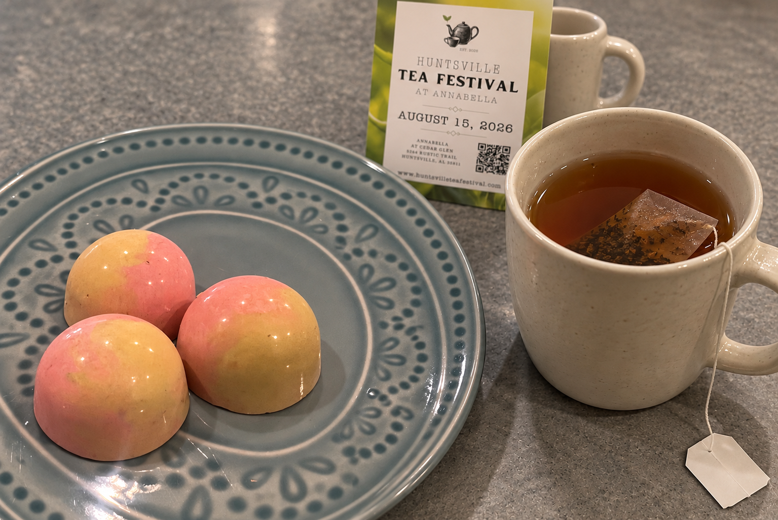 Earl Grey bonbons with cream tea mug and Huntsville Tea Festival sign
