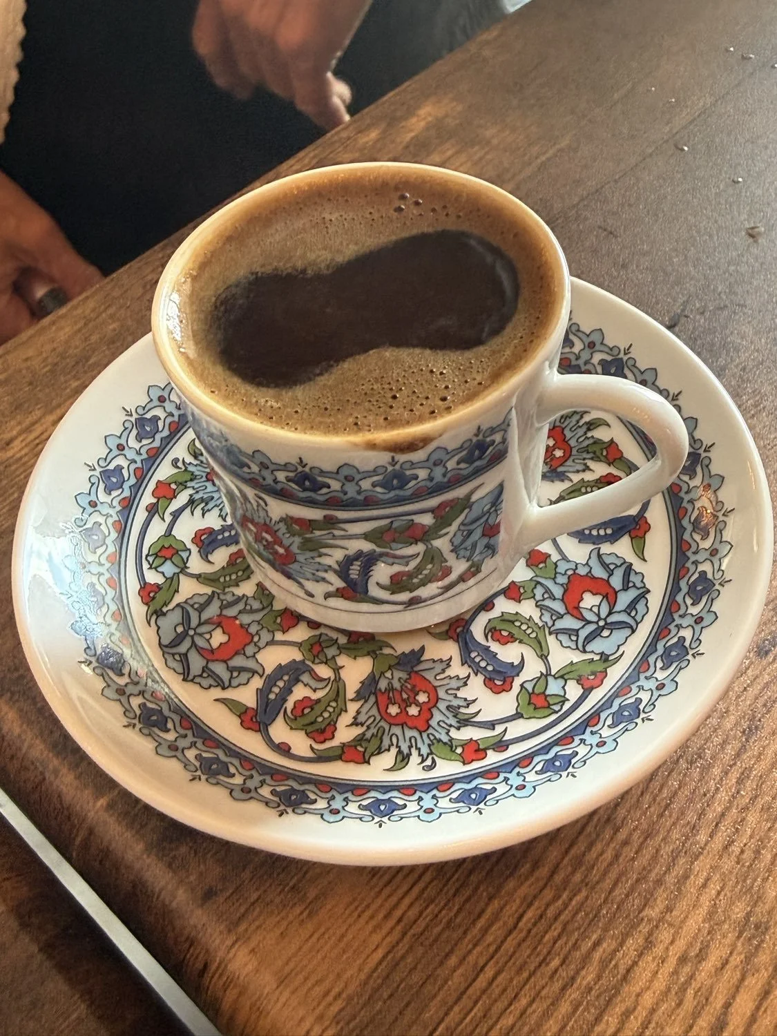 Turkish coffee in a hand-painted cup and saucer at Clay Pot in Naples
