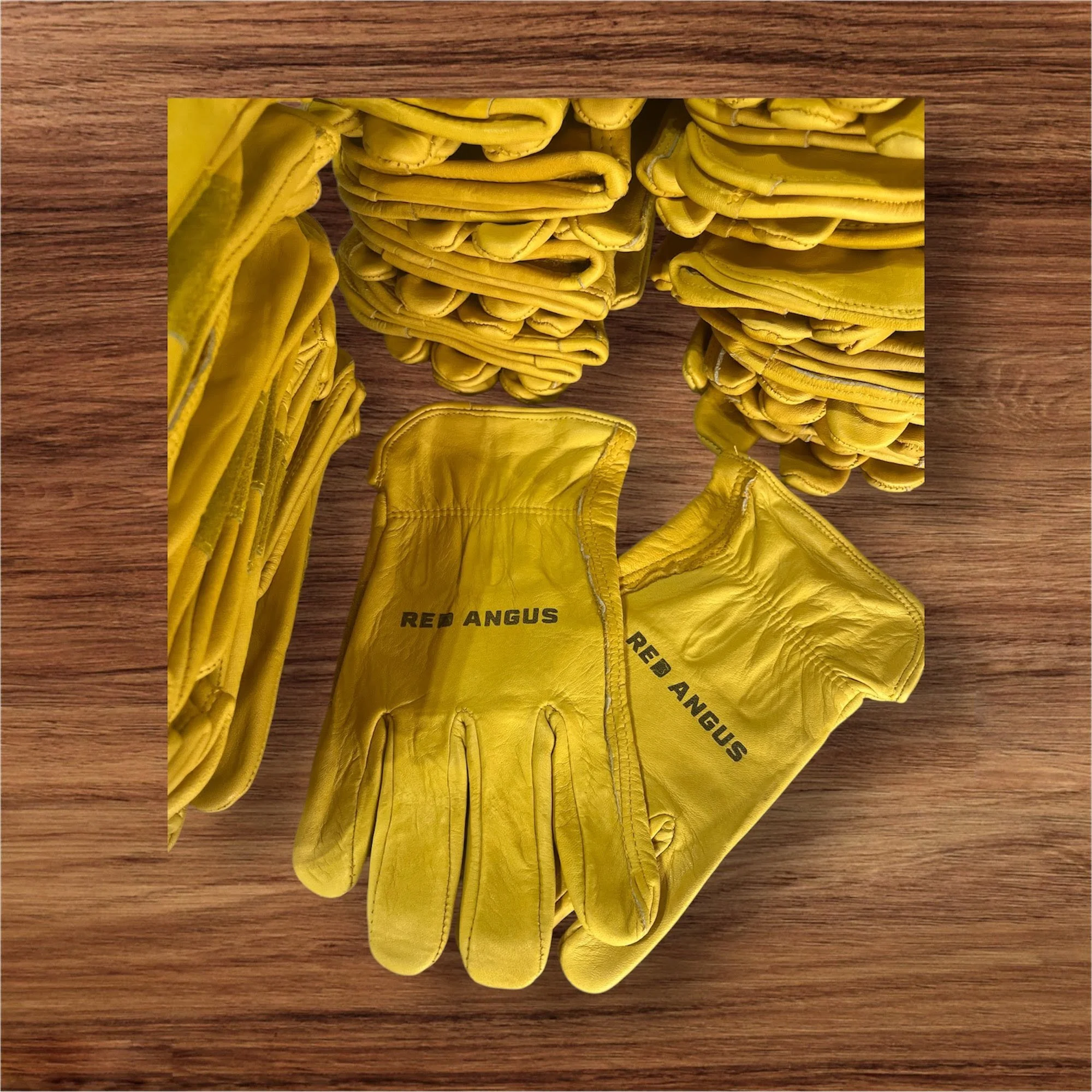 A collection of yellow baseball gloves arranged on a wooden surface.