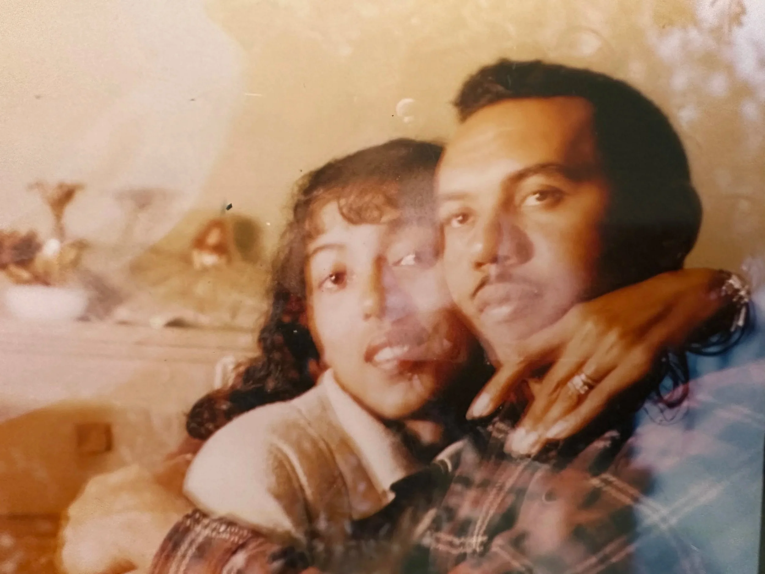 Two people hugging each other closely in a warm, affectionate pose.