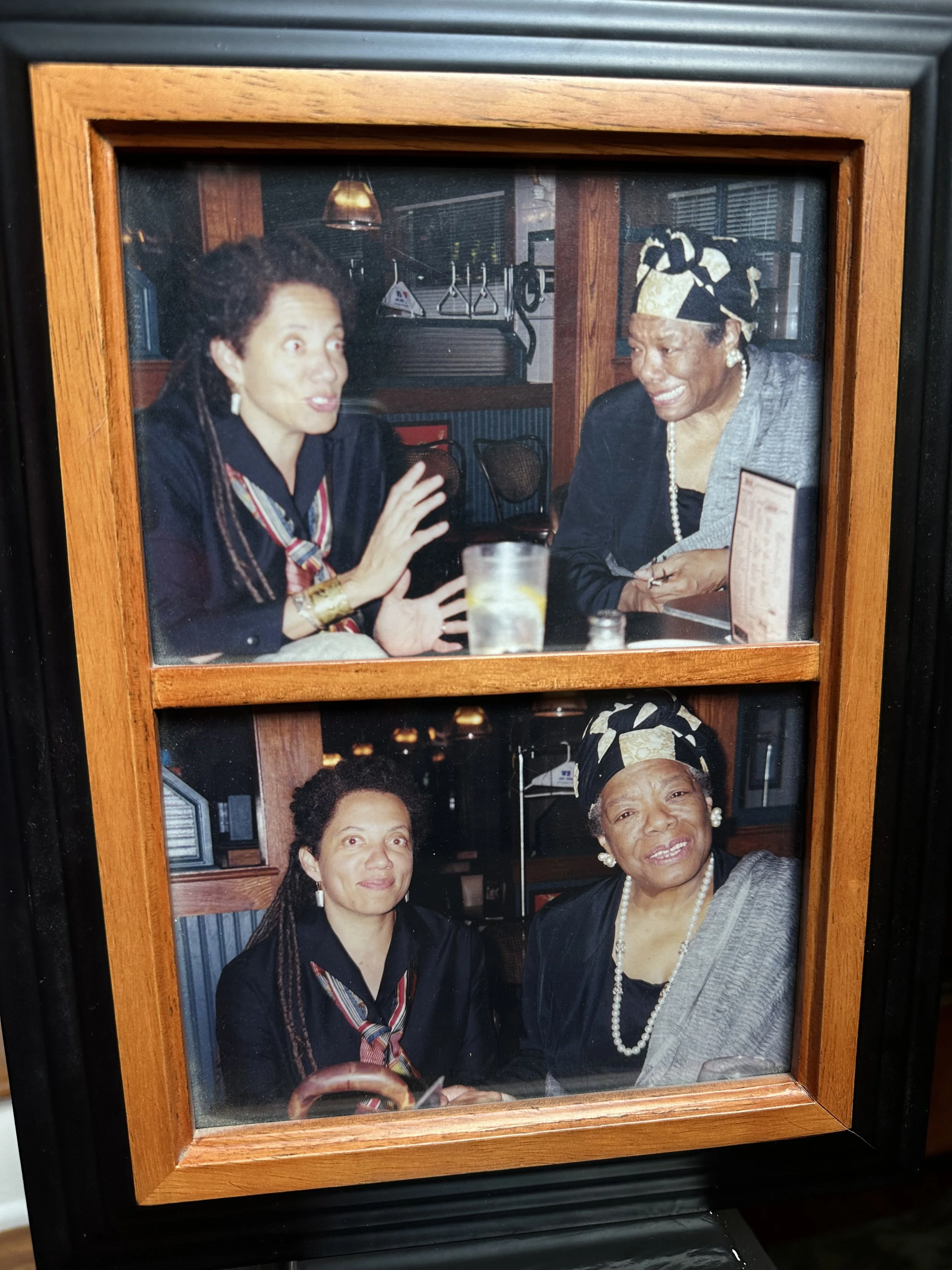 Photographs of Nikky Finney and Maya Angelou sitting at a table in a restaurant, engaged in conversation and smiling. They are dressed in formal attire with jewelry and head coverings. The background shows a window and gym equipment.