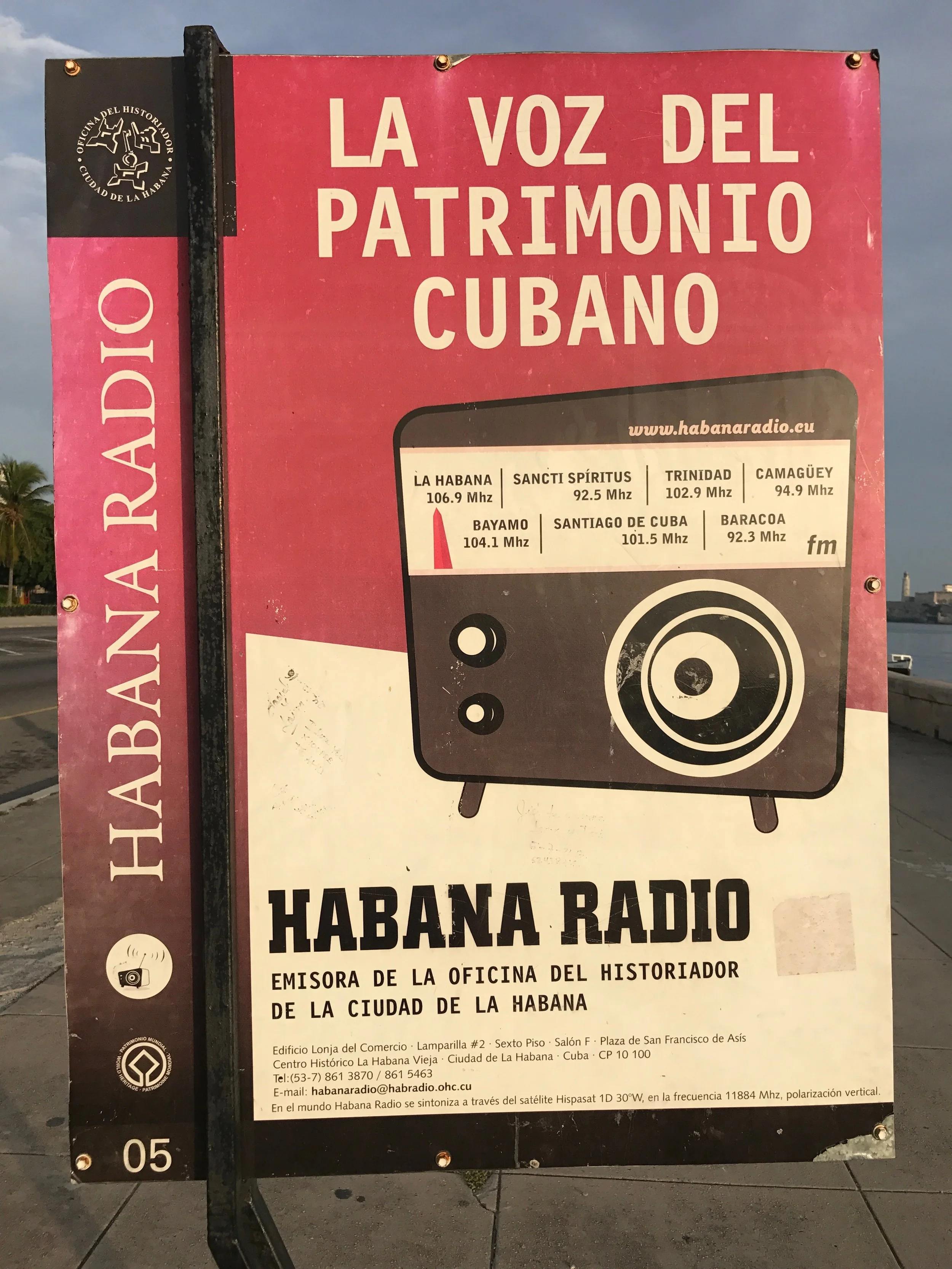 Sign for Havana Radio featuring logo, frequency information for various radio stations in Havana, Cuba, and contact details at the bottom.