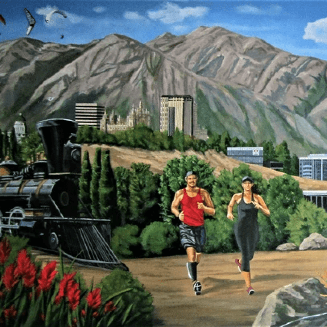 A mural depicting a mountainous landscape with a train and two people running on a trail in the foreground.