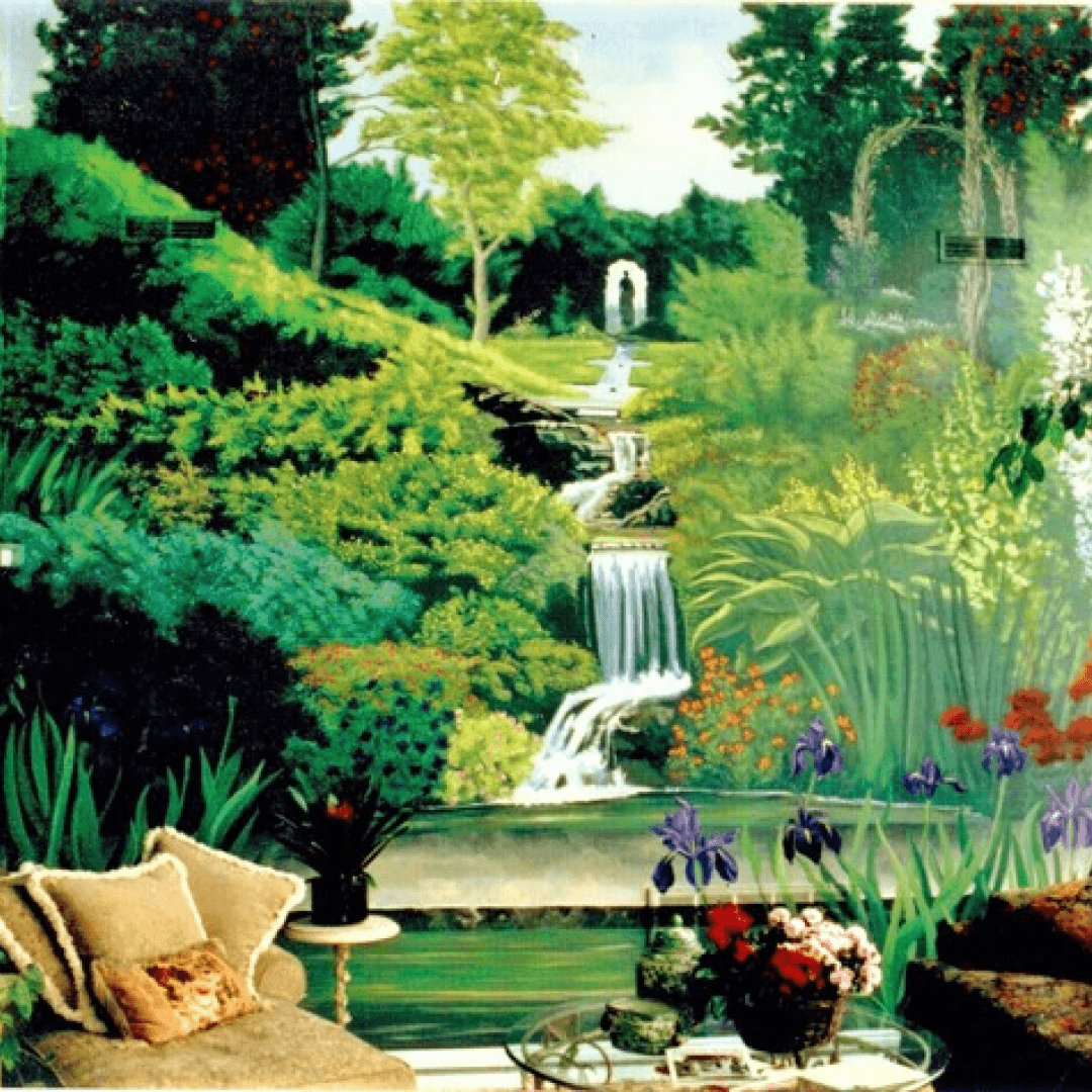 Interior room with a large mural of a lush green garden and waterfall, furniture including beige sofa with pillows and glass coffee table with floral arrangements.