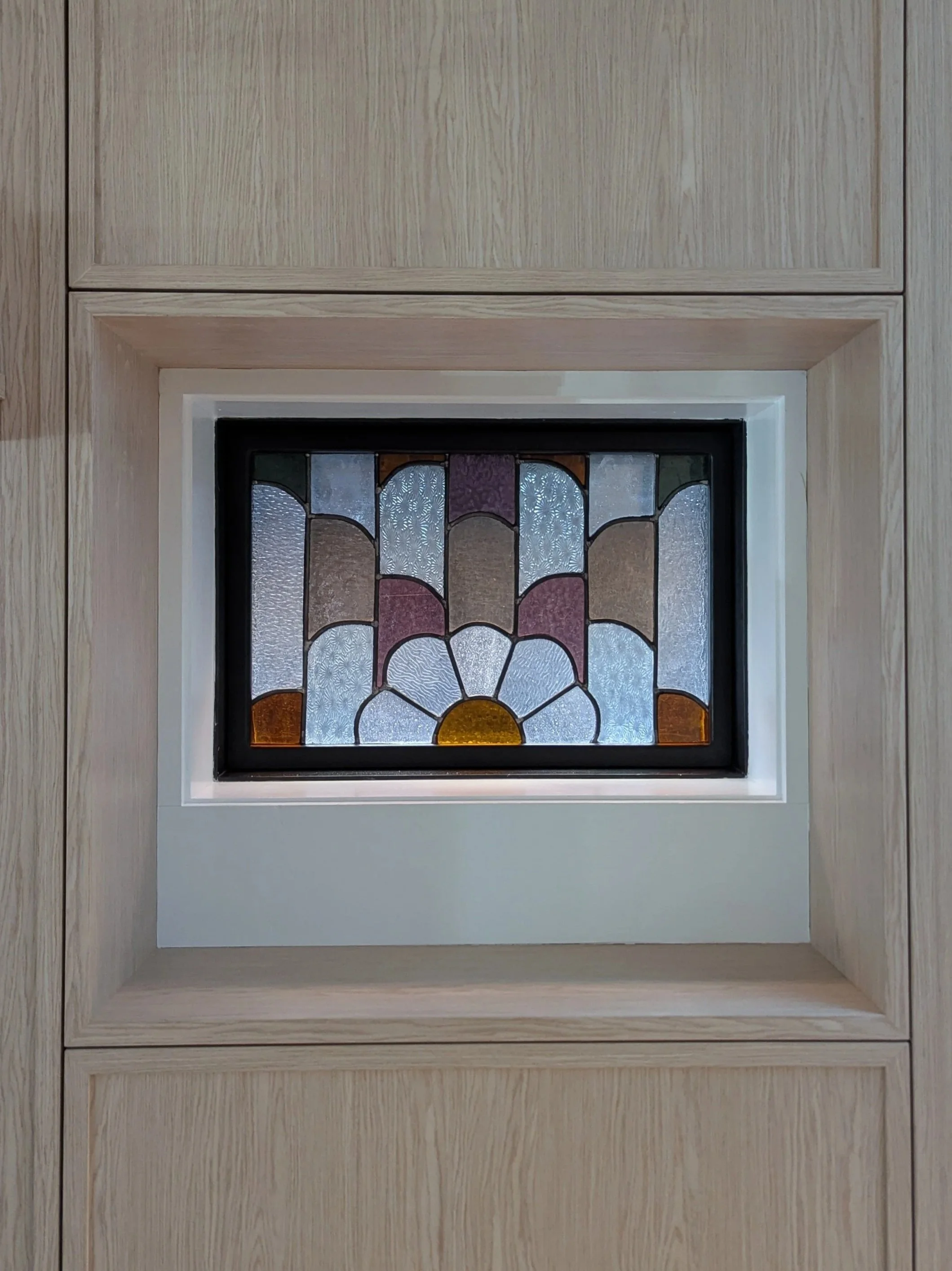 Leaded glass panel installed in window.