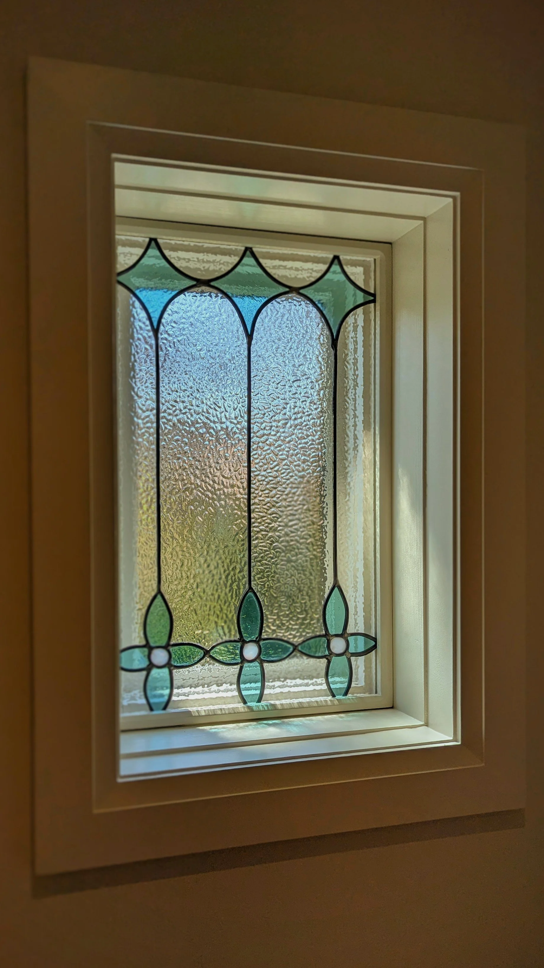 Leaded glass panel installed in window.