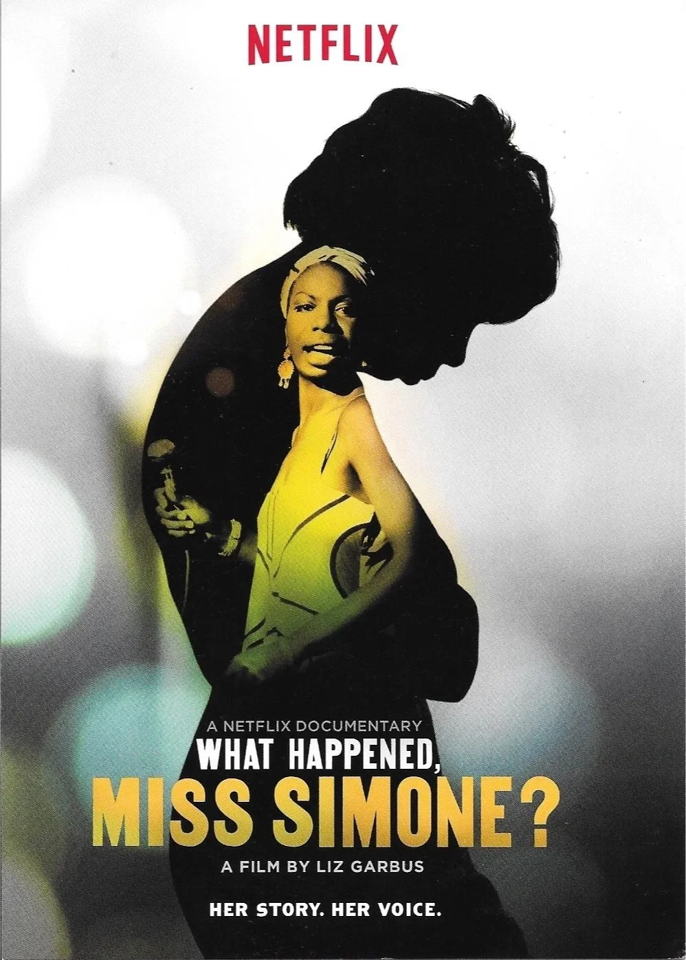 Poster for Netflix documentary titled 'What Happened, Miss Simone?' featuring a silhouette of a woman with her head bowed, and an overlay of a close-up of Nina Simone's face in a yellowish tone. The background is mostly white with some blurred lights.