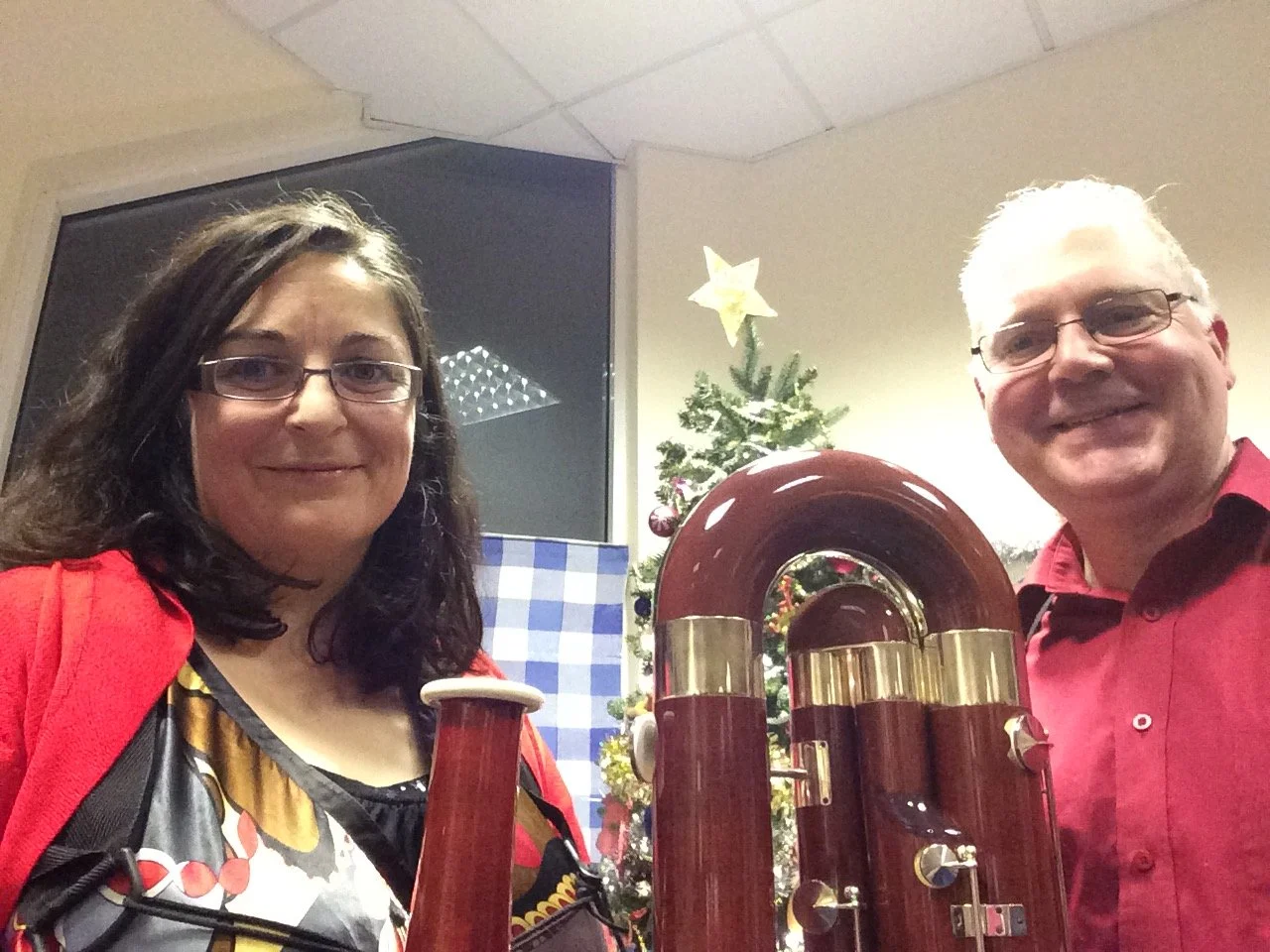 Katy and Miles and bassoons infront of a Christmas tree