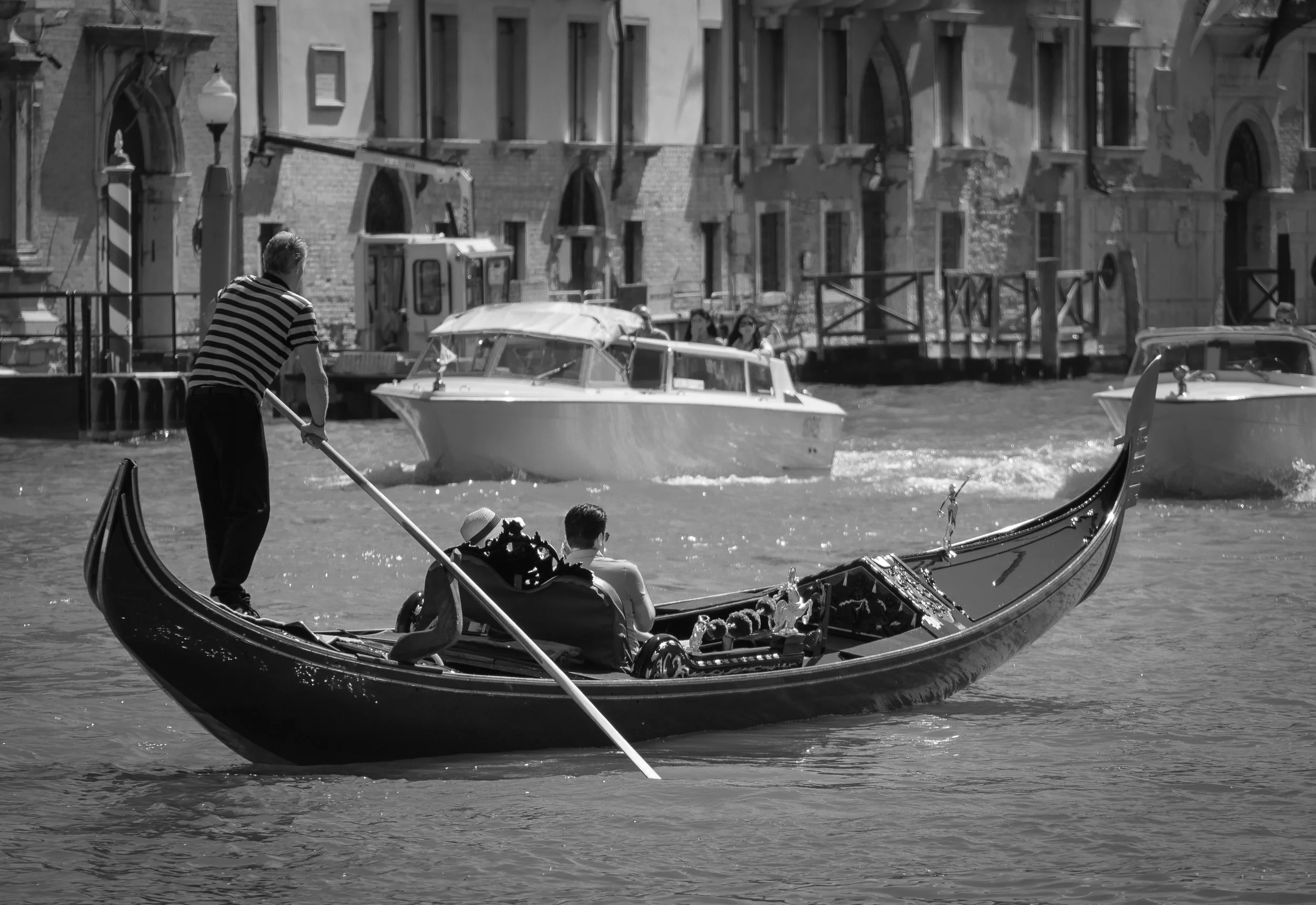 Gondola with gondolieri and couple on the grand canal, Venice