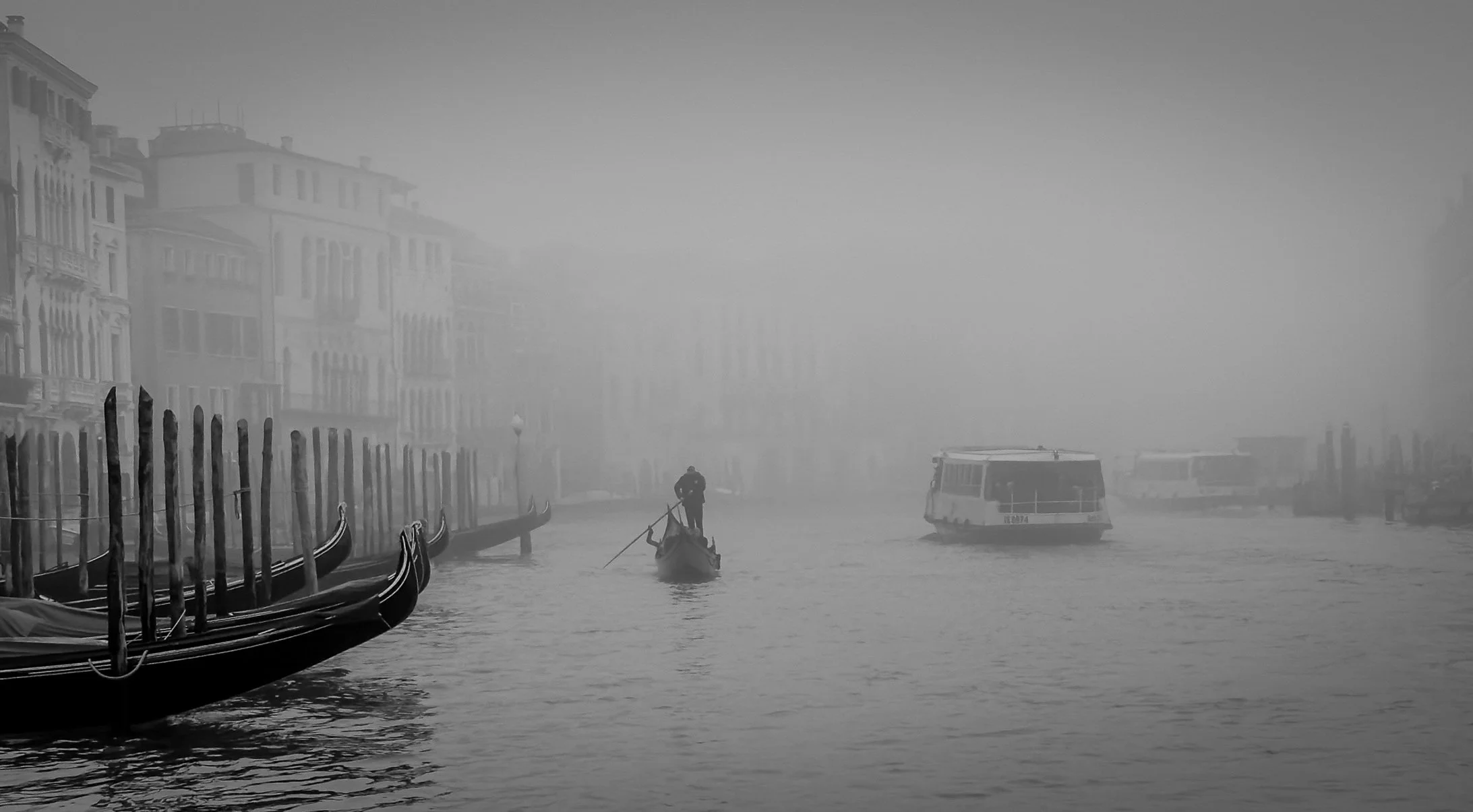 A gondola and vaporetto in the fog on the Grand Canal, Venice
