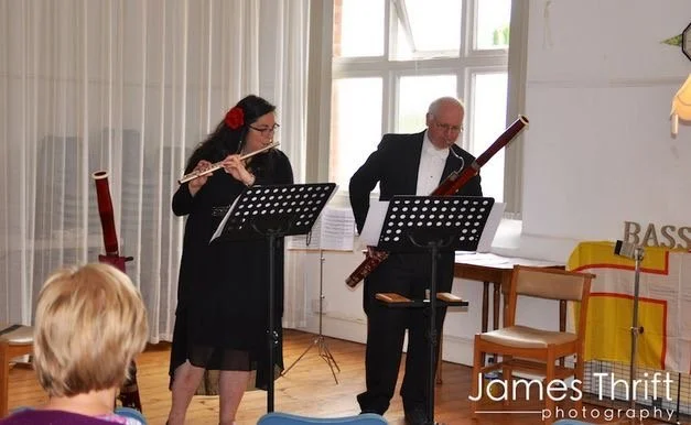 Katy and Miles playing flute and bassoon in concert dress