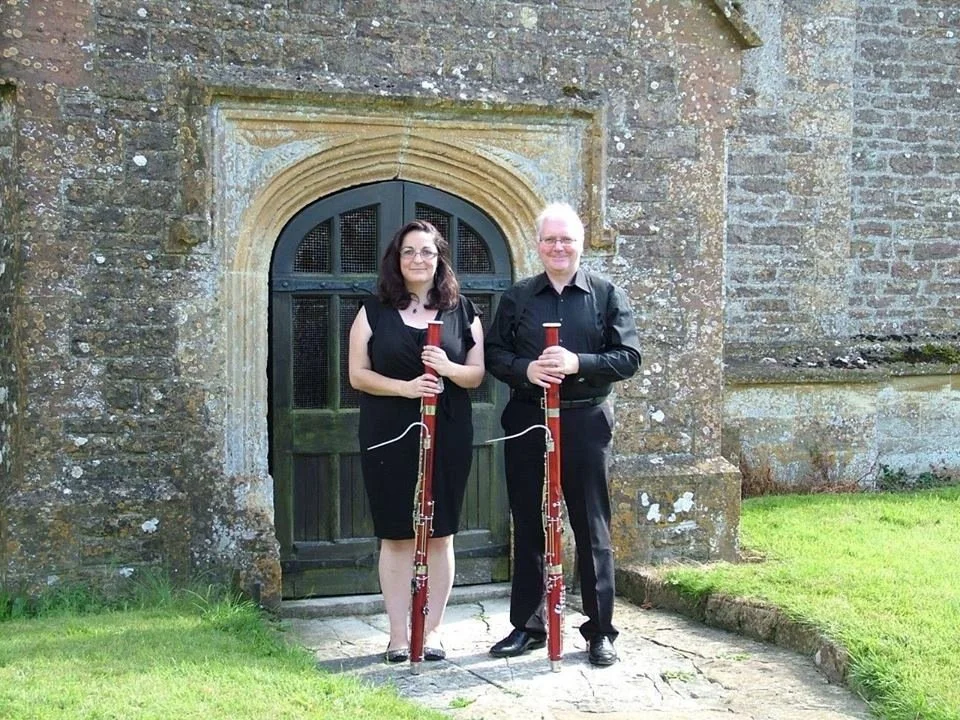 Katy and Miles with bassoons outside Beer Hackett church