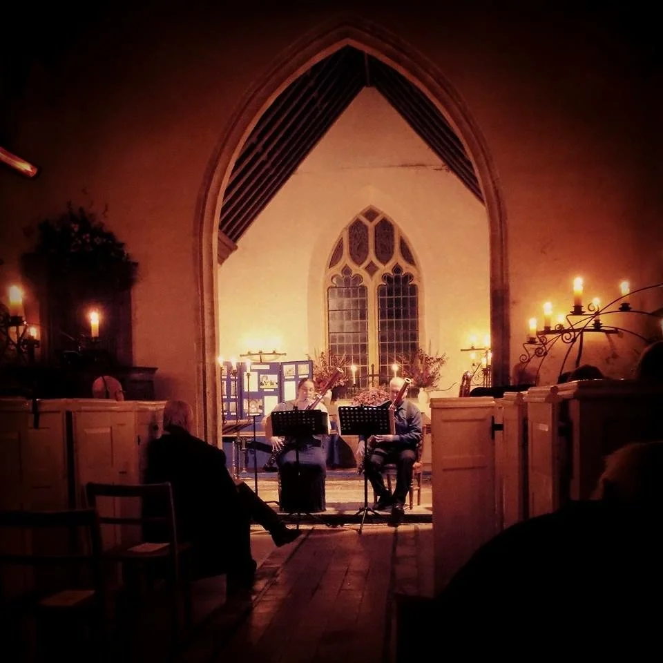 Katy and Miles playing by candlelight at Holnest Church