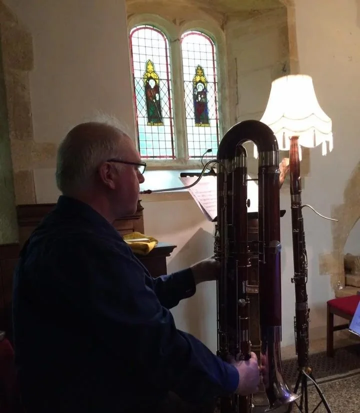 Miles playing contrabassoon next to the bassoon standard lamp