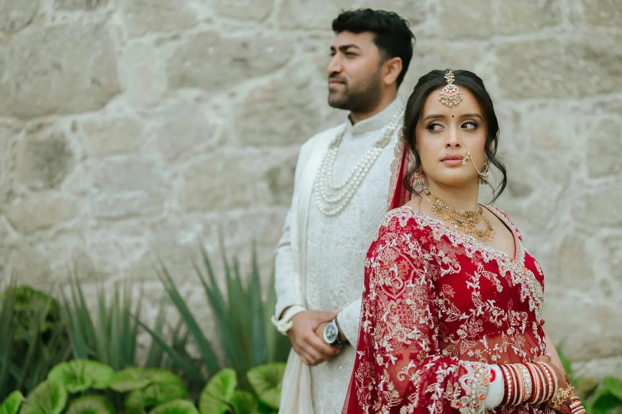 A indian couple dressed in traditional Indian wedding for their hindu ceremony in Braga Portugal at Quinta Lago dos Cisnes.
